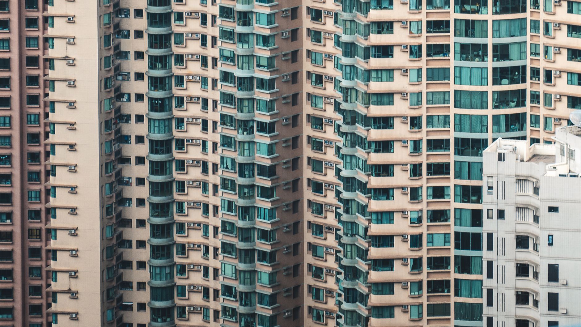 Close-up view of towering residential buildings in Hong Kong, showcasing urban density.