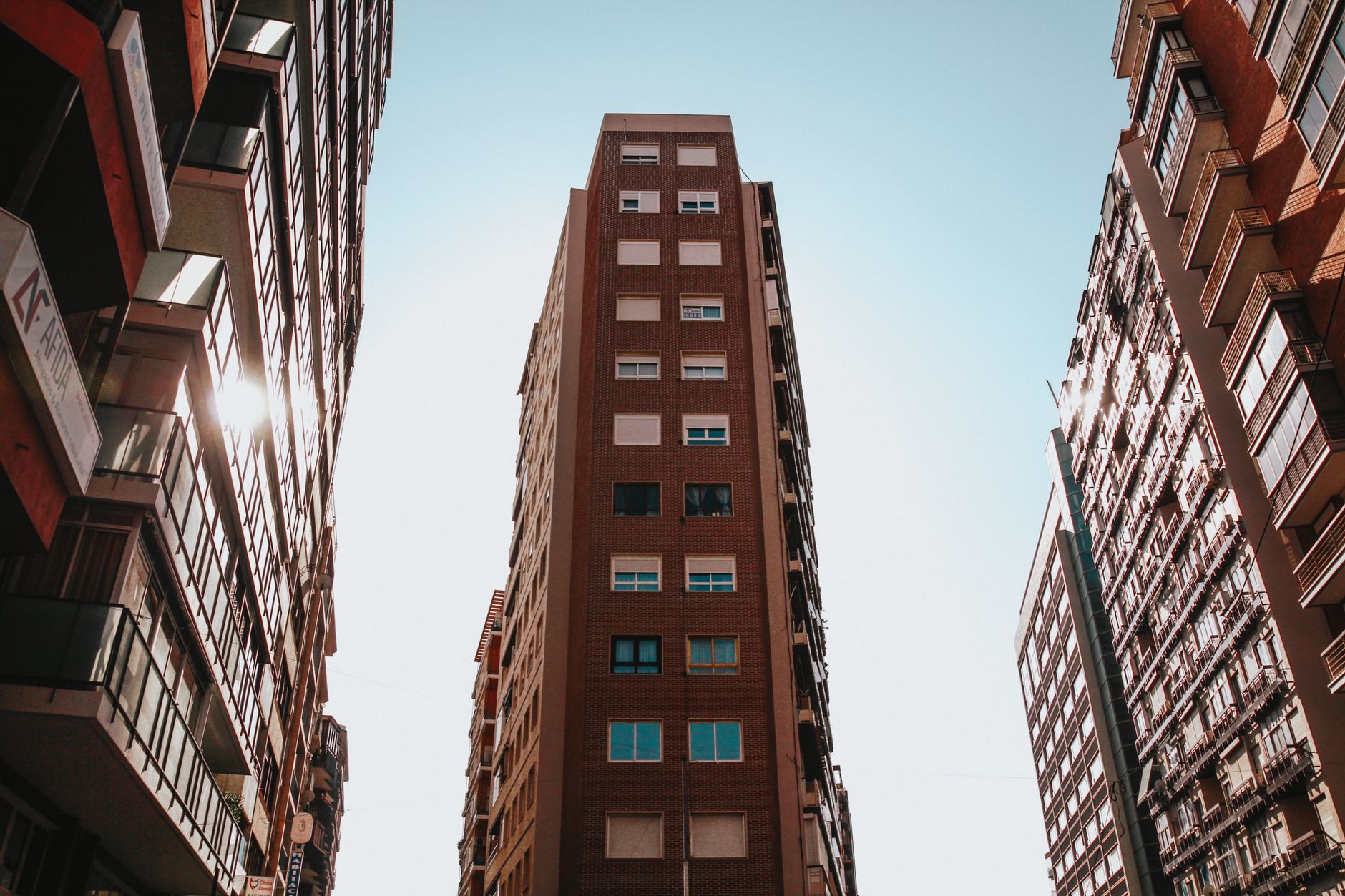 Capture of towering buildings in Alicante, Spain showcasing modern urban architecture and city life.