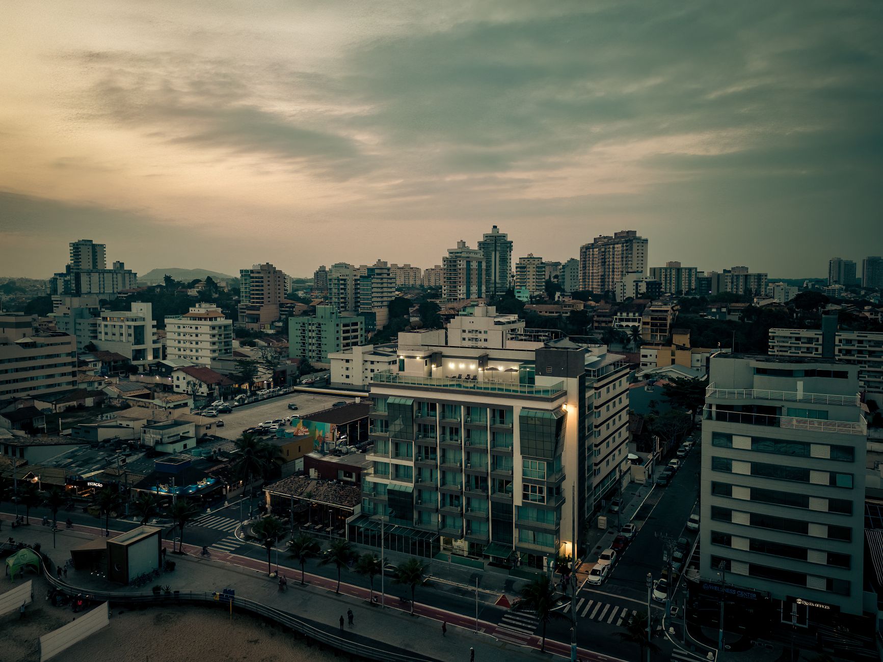 Captivating aerial view of Macaé, RJ Brazil's cityscape during sunset, showcasing urban architecture and vibrant skyline.