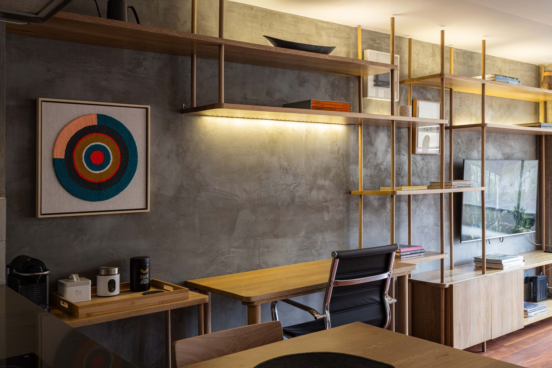 Contemporary interior design featuring wooden shelves, a desk, and modern decor.