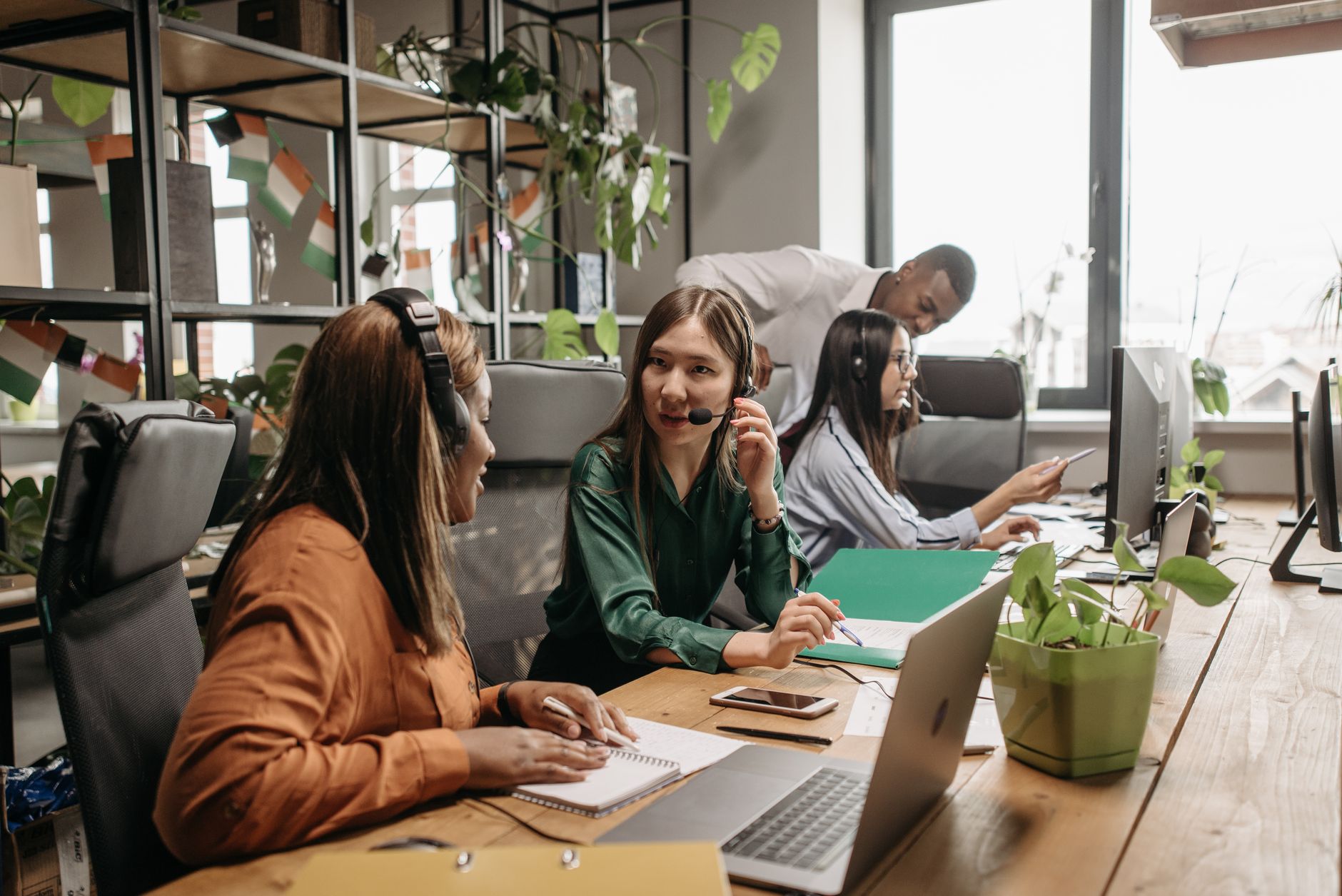 Employees working together in a modern call center environment highlighting teamwork and diversity.