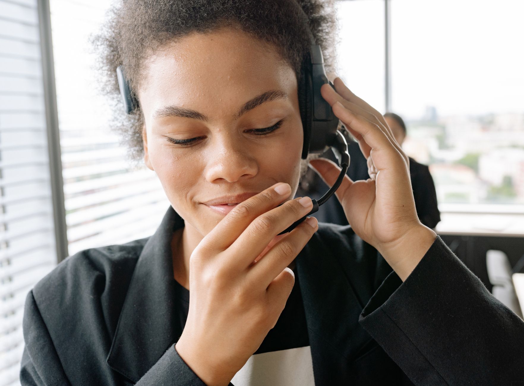 Close-up of a confident call center agent in a modern office setting.