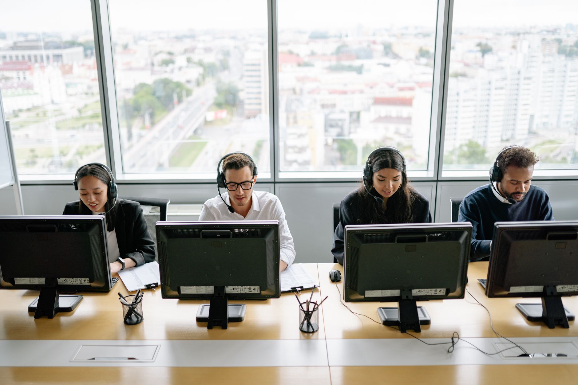 Team of diverse colleagues working efficiently at a modern call center.