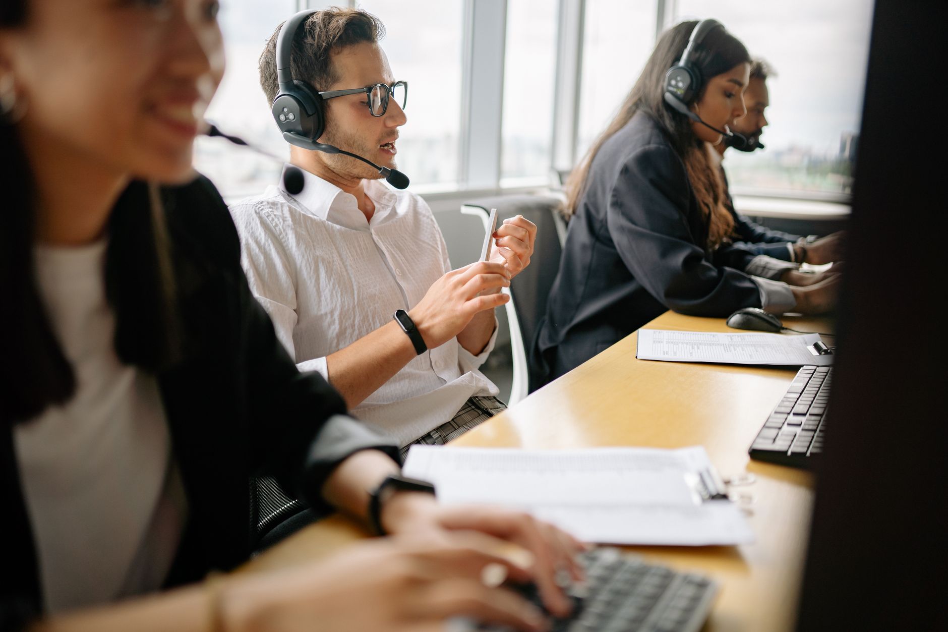 A diverse team of call center agents working together in a modern office setting.