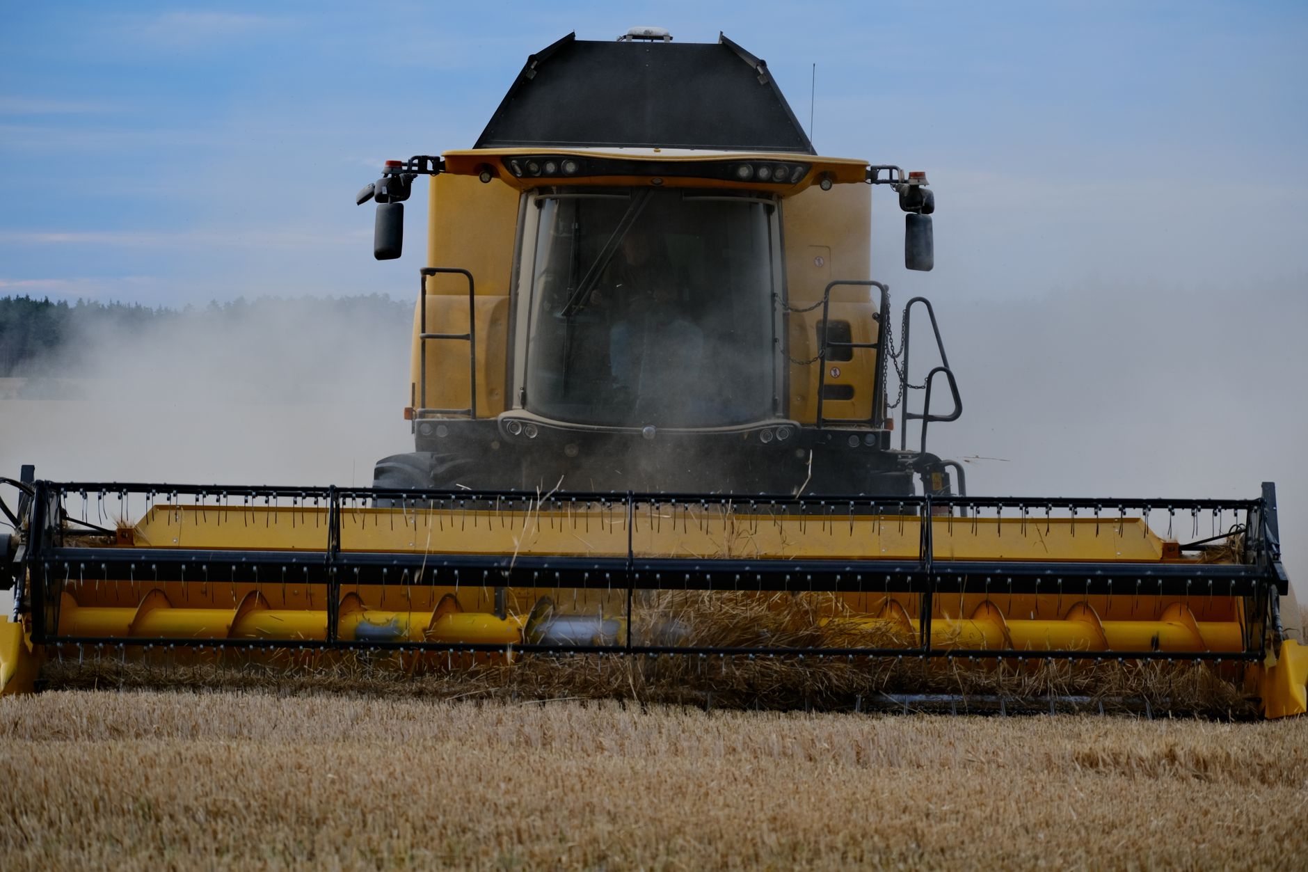 A combine harvester at work in a wheat field during harvest season.