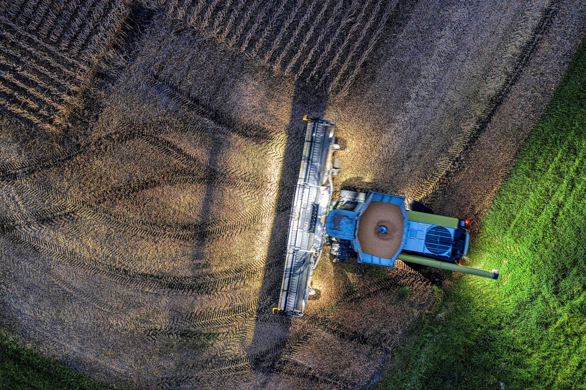 A drone's eye view of a tractor harvesting crops in a Minnesota field.
