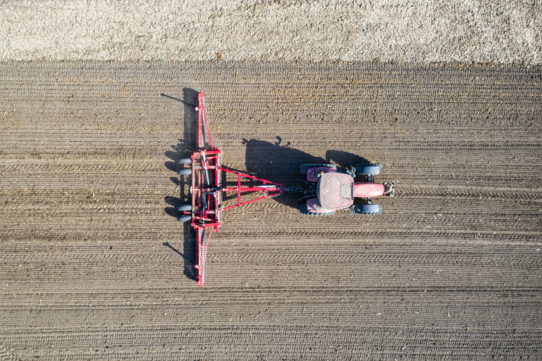Drone shot of a tractor plowing a field in Plainview, MN. Ideal for agriculture concepts.