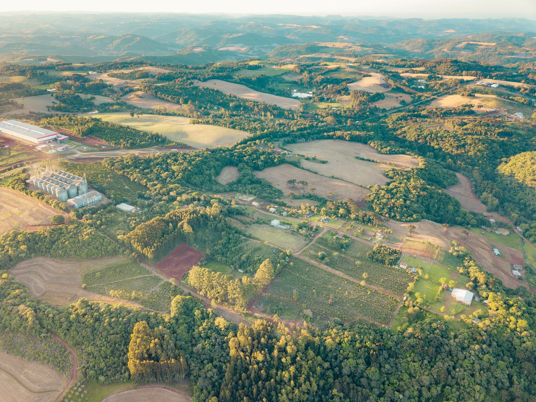 Aerial view of farmlands and countryside in Centro, RS, Brazil during daytime.