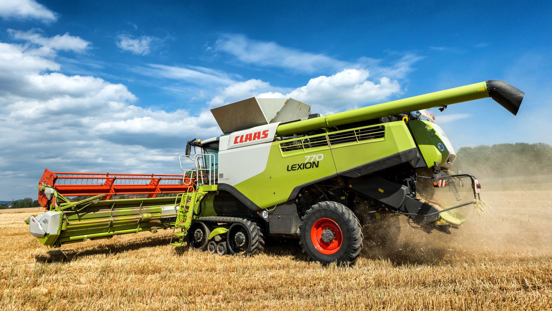 Green CLAAS LEXION harvester working in a summer field in Holzminden, Germany.