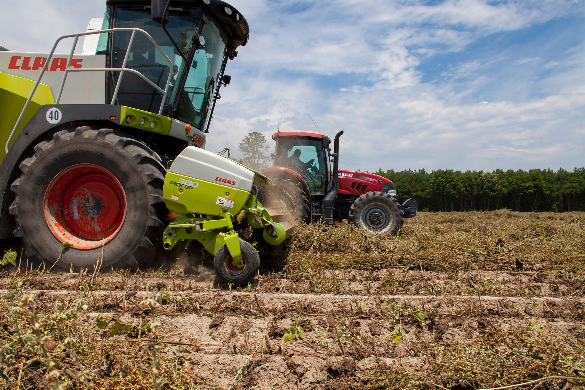 Advanced tractors and harvesters work together in a North Carolina field.