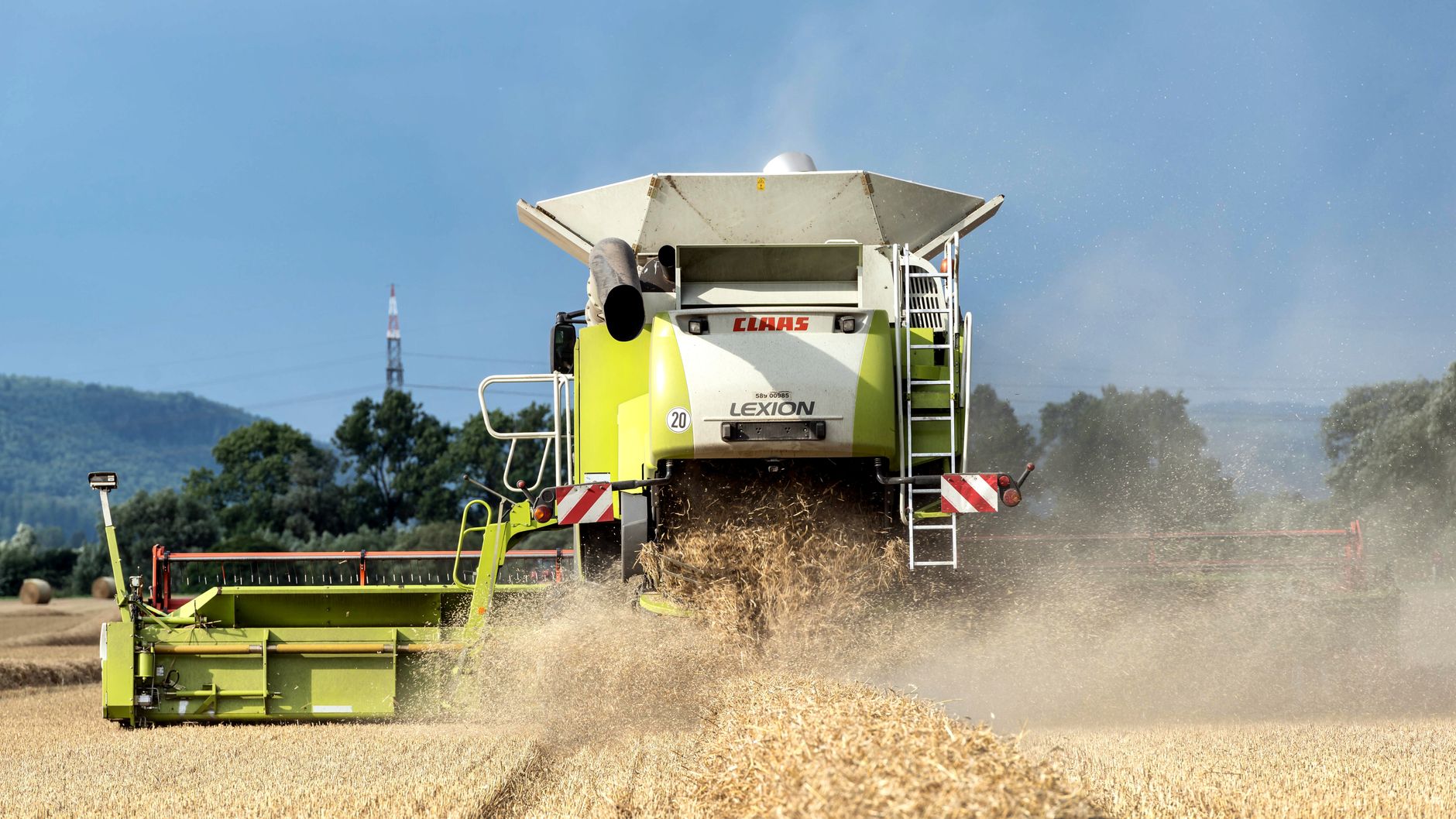 Combine harvester working in a rural field during summer.