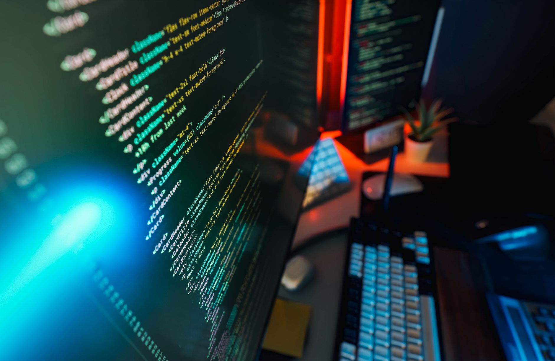 Futuristic workspace featuring a glowing computer screen with coding displayed, ideal for technology and programming concepts.