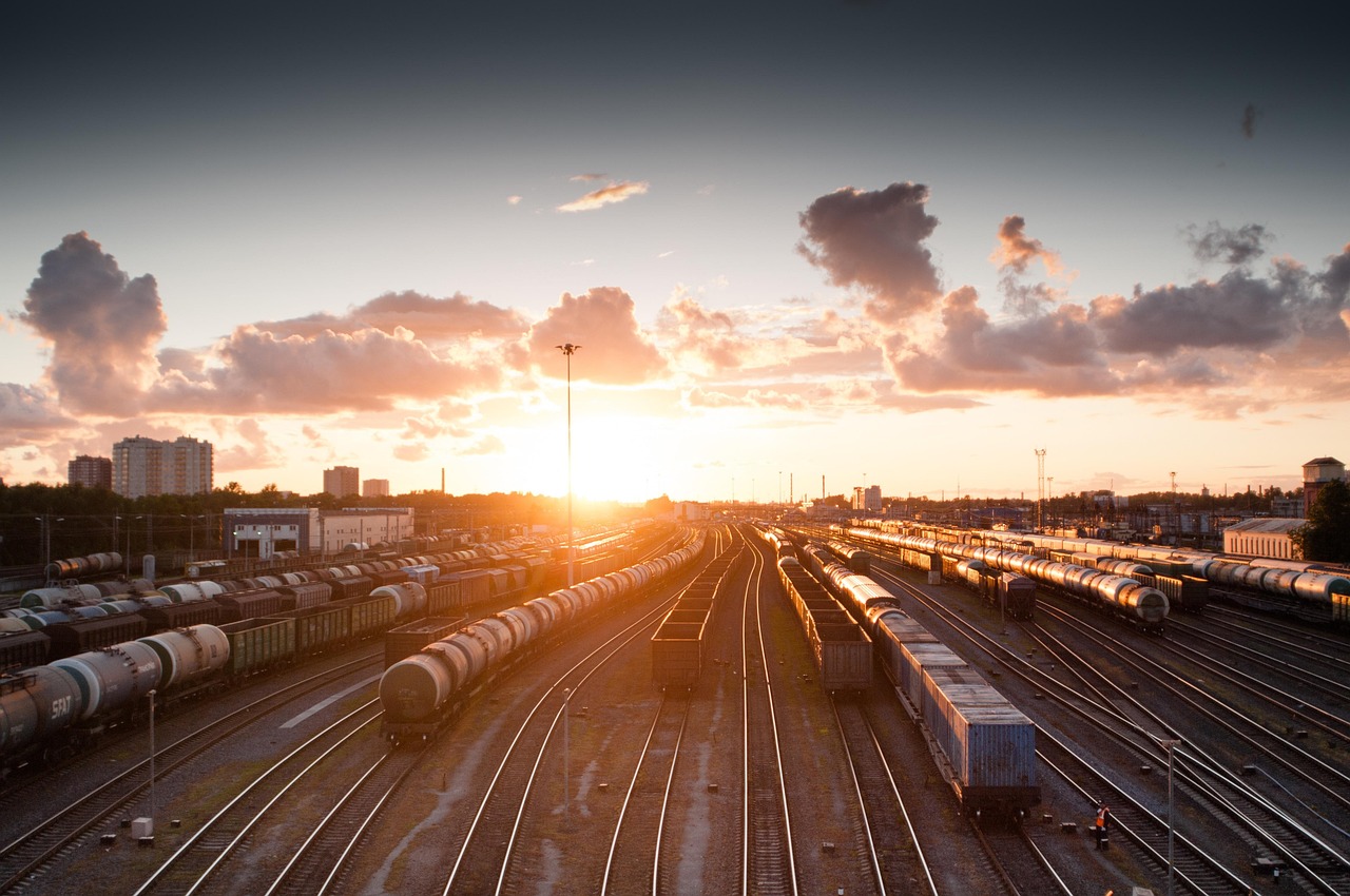 train, sunset, nature, tracks, railroad, transportation, transport, travel, station, railway, rail, industry, platform, locomotive, traffic, technology, sky, carriage, city, speed, departure, industrial, dusk, wagon, light, transit, modern, urban, street, business, delivery, subway, steel, perspective, motion, building, passenger, journey, logistic
