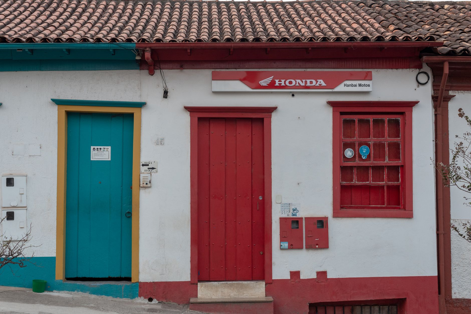 Vibrant building facade with colorful doors in Sabará, Brazil showcasing colonial architecture.