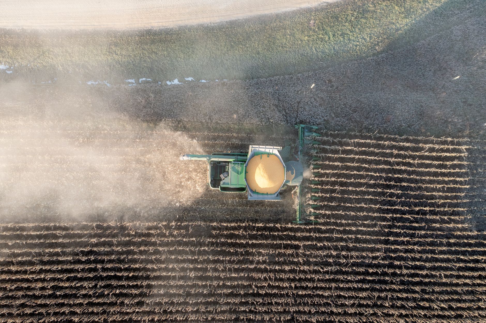 Drone captures a harvester working through dusty fields in Theilman, Minnesota.