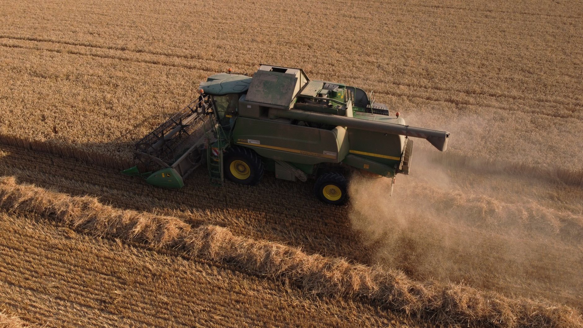 Aerial view of a combine harvester working through a wheat field in summer at Saigneville, France.