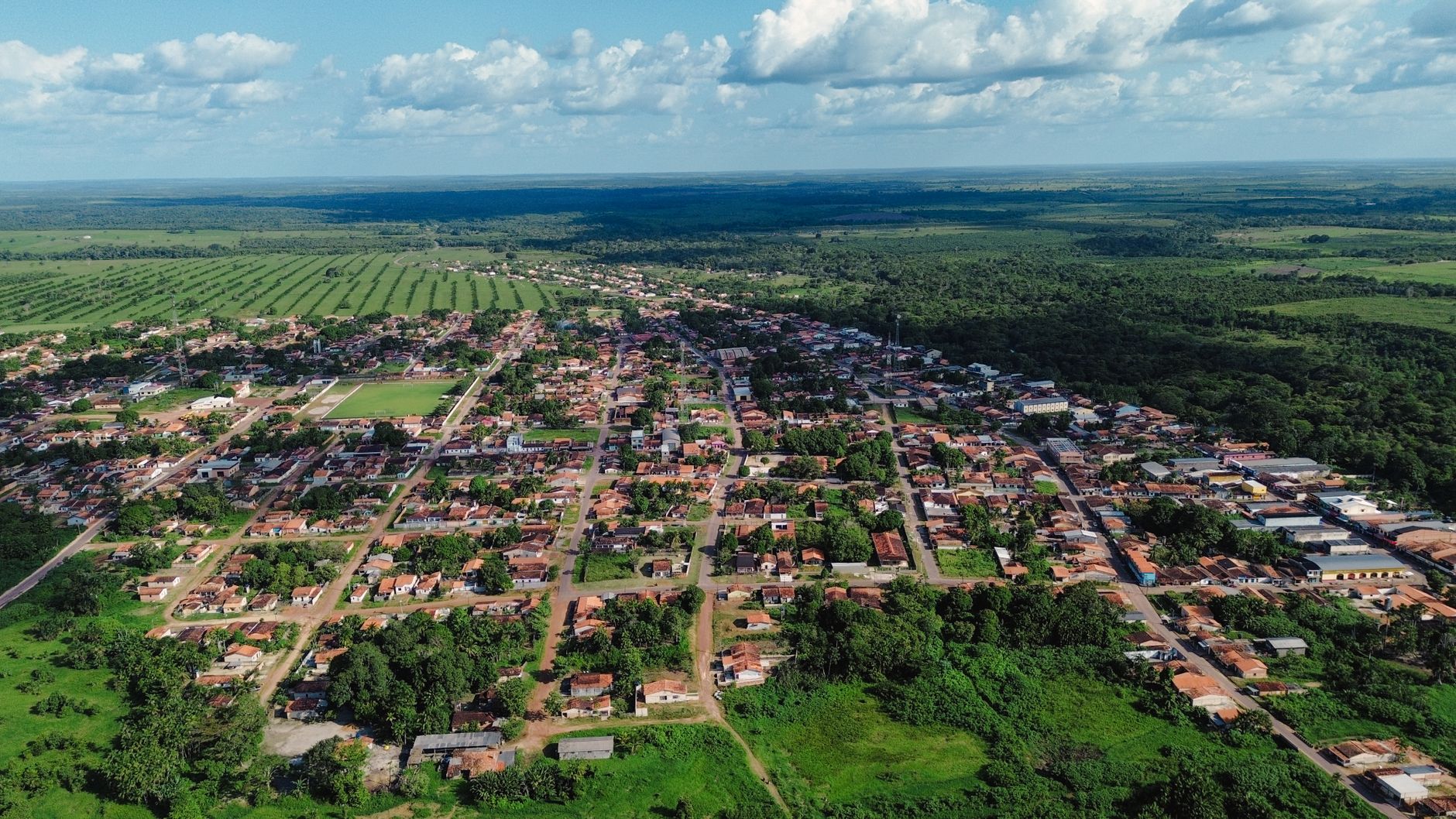 Aerial view of Garrafão do Norte town and surrounding lush fields in Brazil.