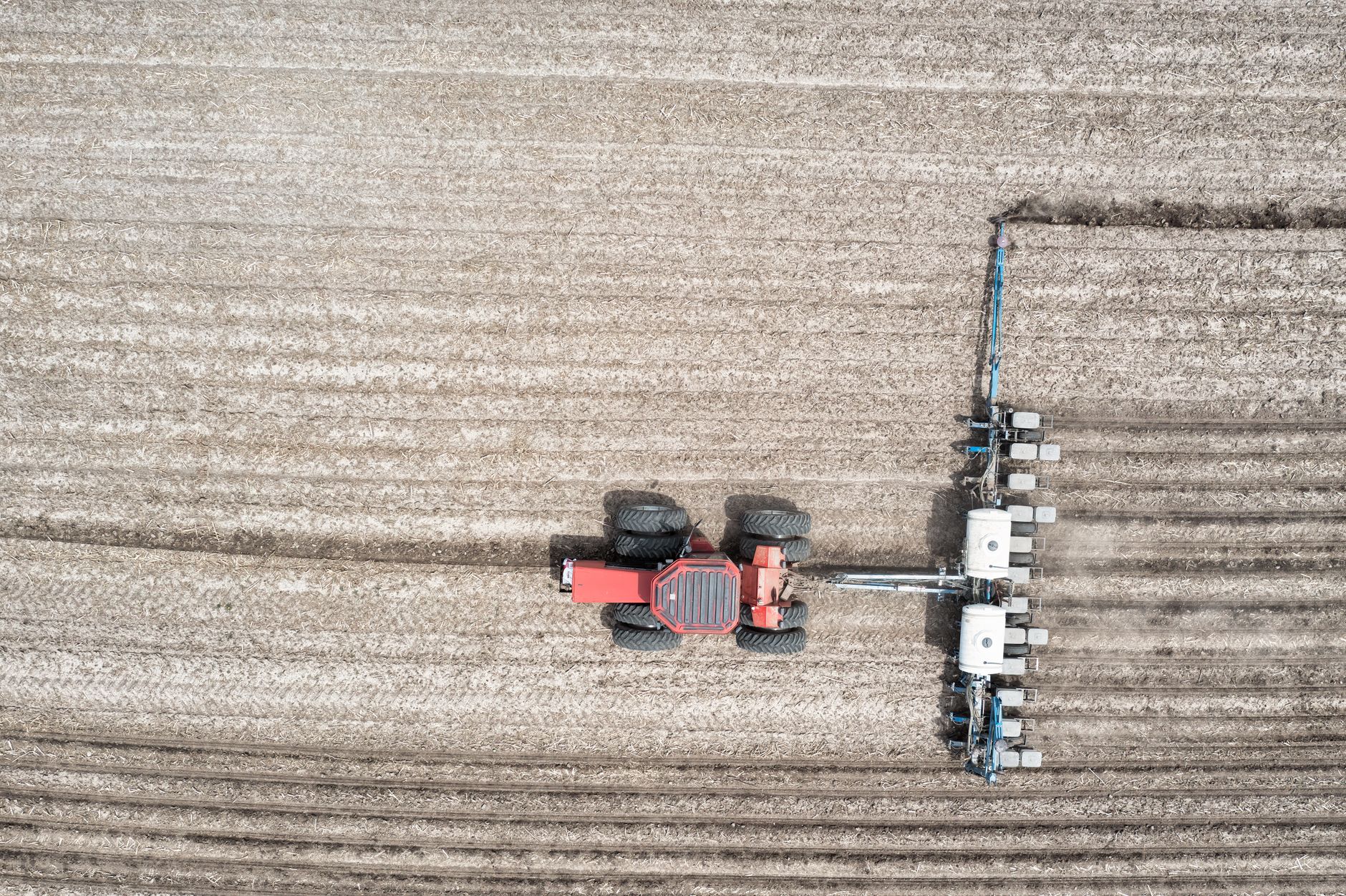 Drone view of tractor ploughing a field in rural Minnesota, USA.