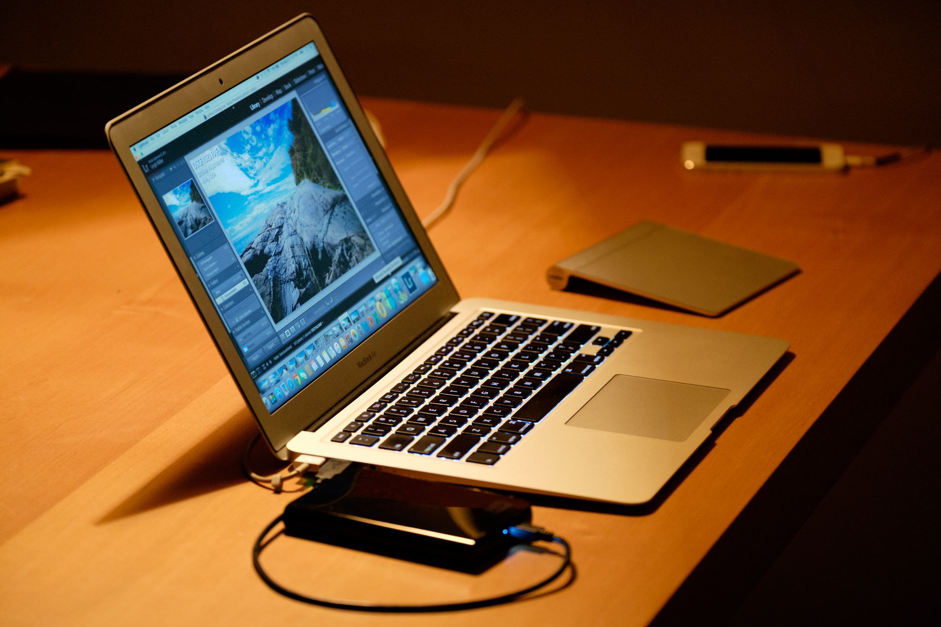 A sleek laptop on a wooden desk in a cozy home office setting, capturing digital workspace vibes.