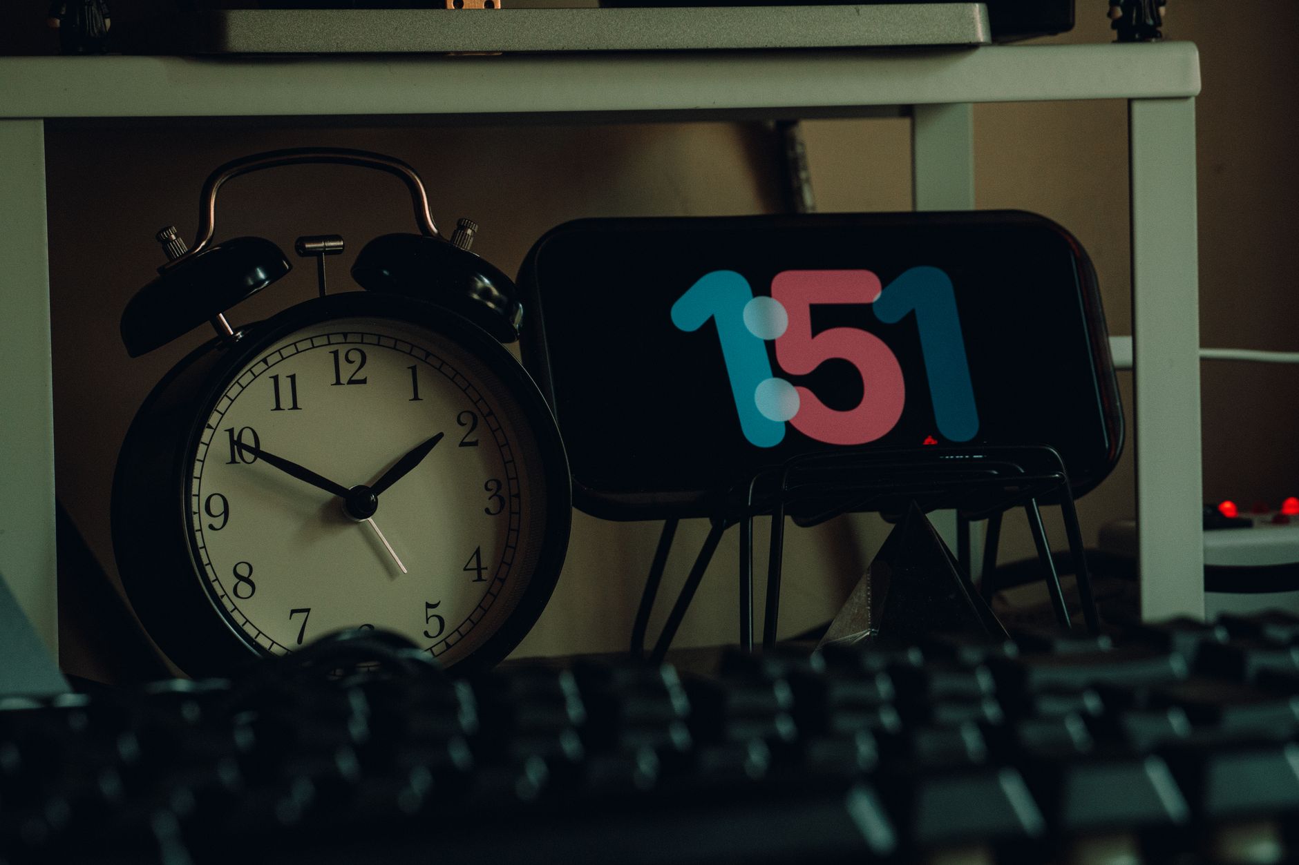 A creative workspace featuring both modern and vintage clocks, enhancing desk decor.