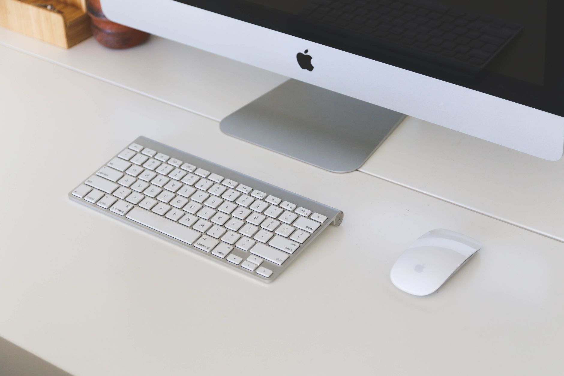 Clean and organized office desk with a computer, keyboard, and mouse in a workplace setting.