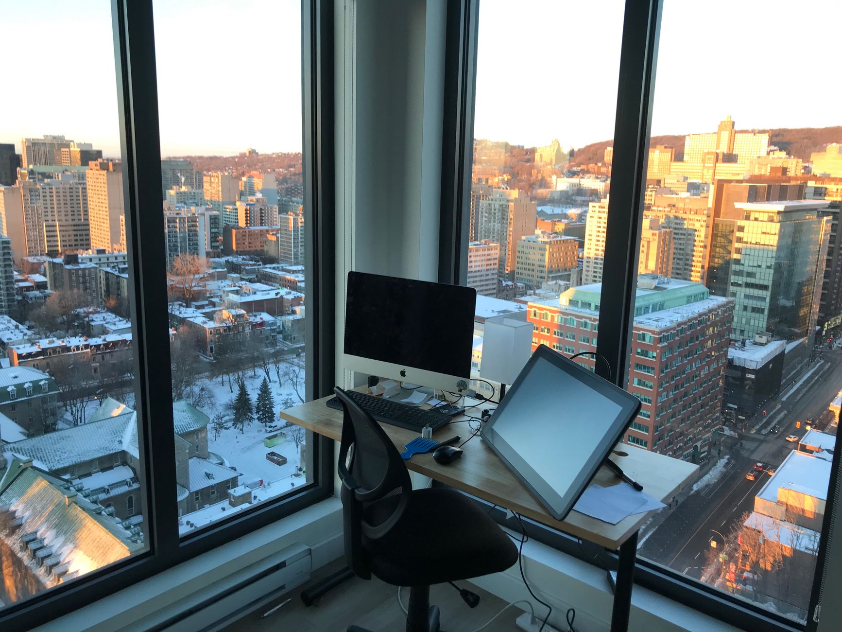 Detroit skyline with professionals using time management tools on laptops in a modern office