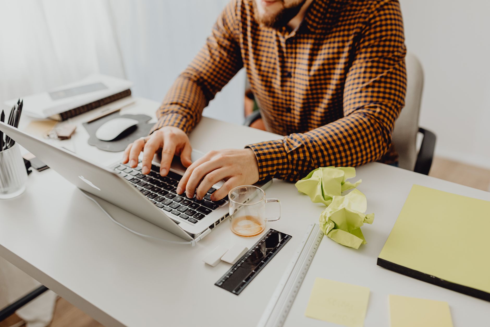 Professional using a Pomodoro timer on a laptop in a modern office