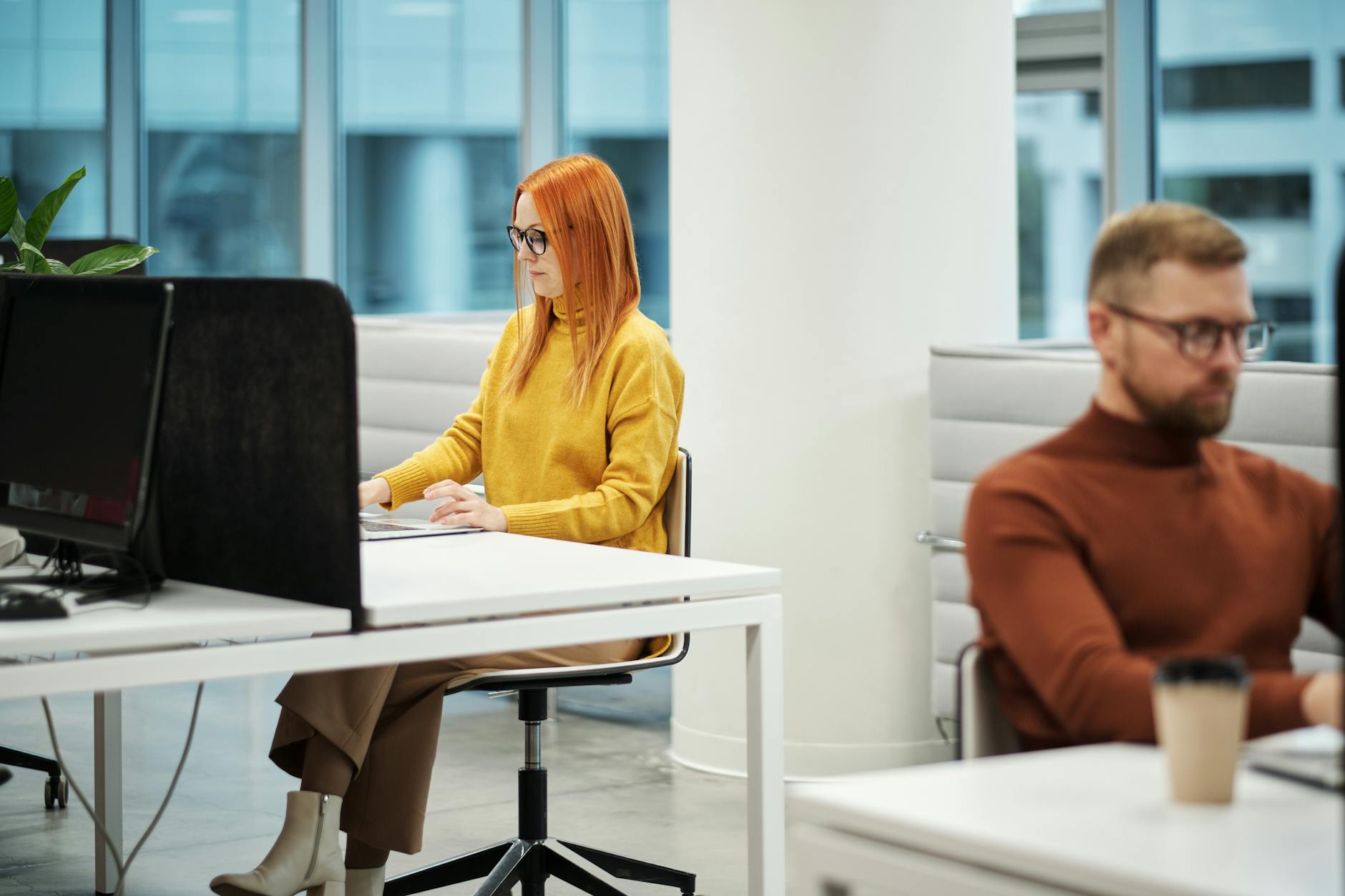 Professional working in a modern Kansas City office with a time management app on screen