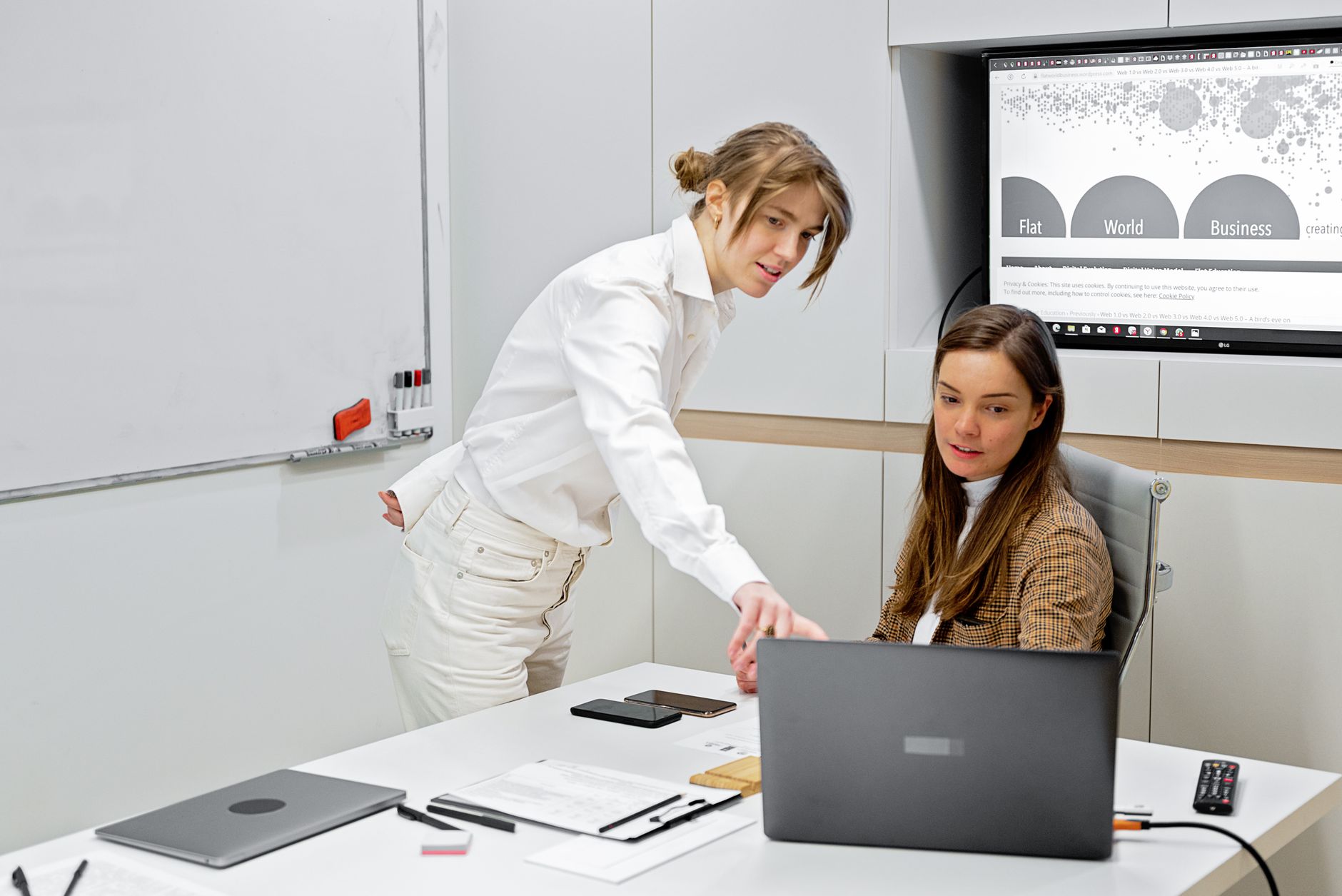 Diverse team analyzing productivity metrics on shared task management dashboard