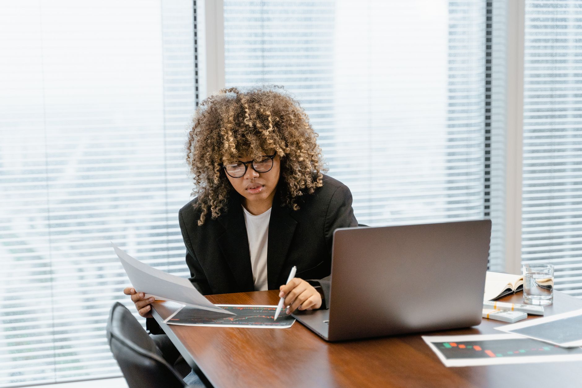 Business analyst evaluating software pricing options on multiple screens