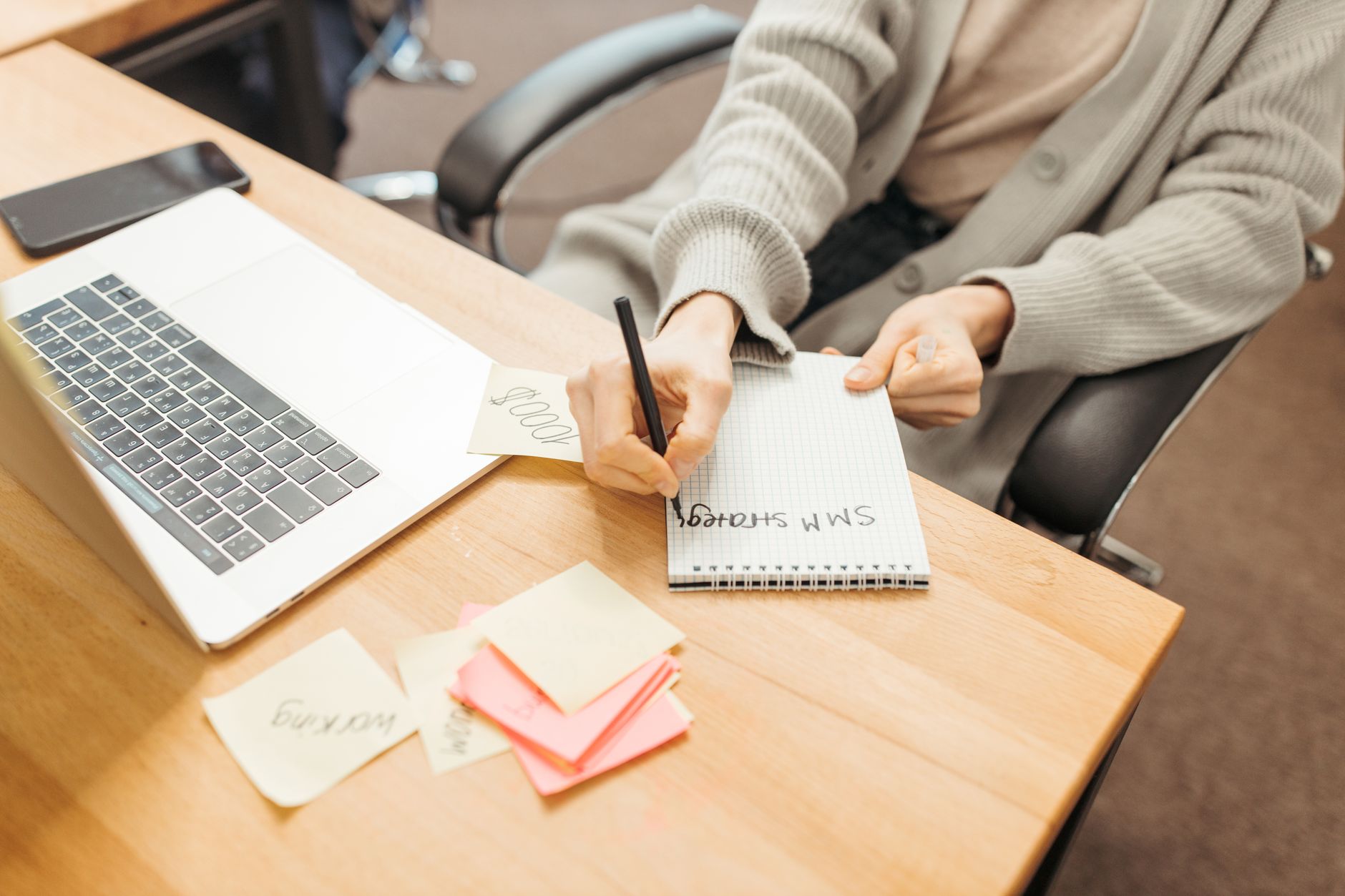 Businessperson evaluating task management software on a laptop in a modern office