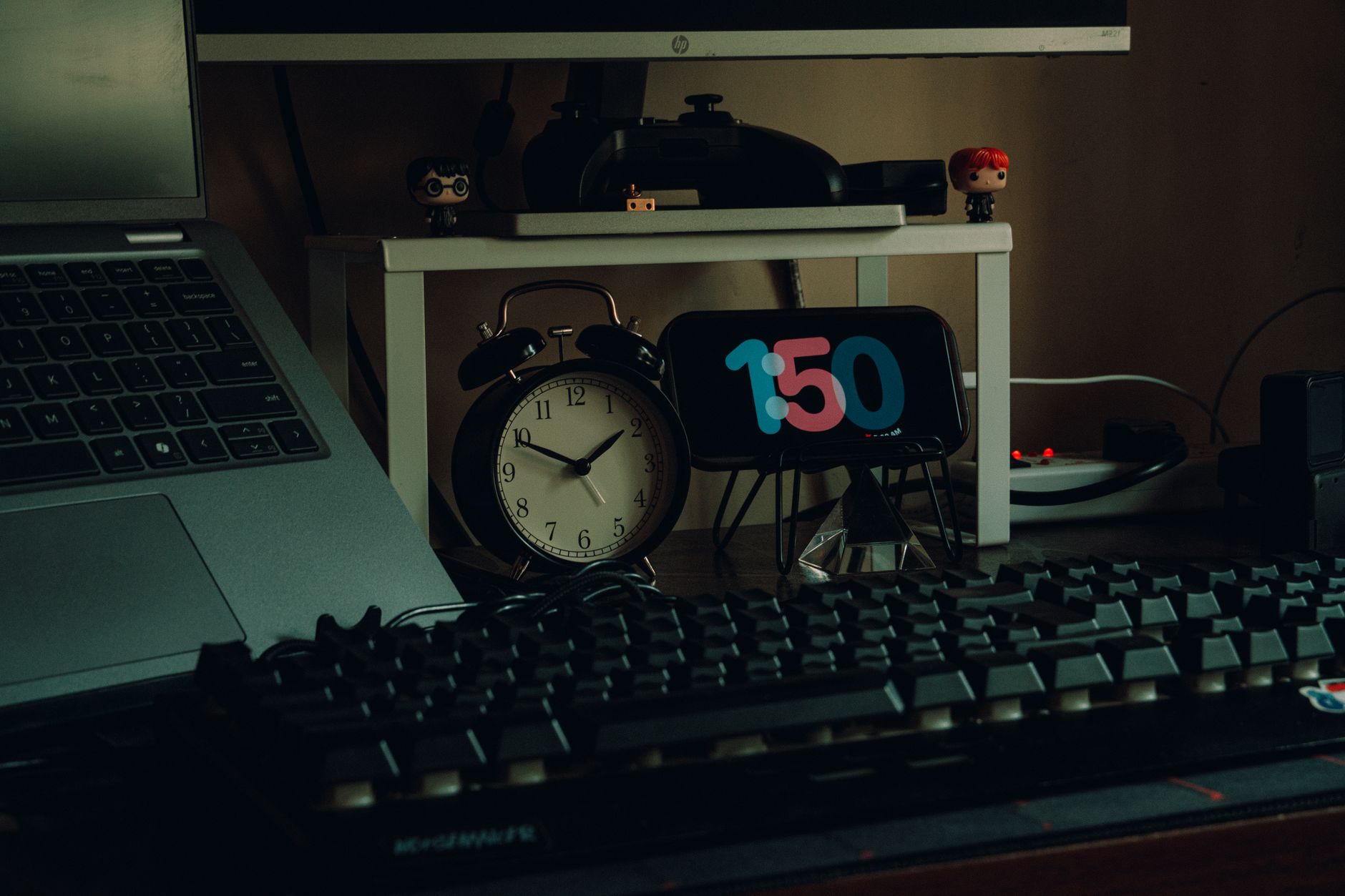 A modern workspace featuring a laptop, analog clock, and creative desk decor for a productive home office setup.