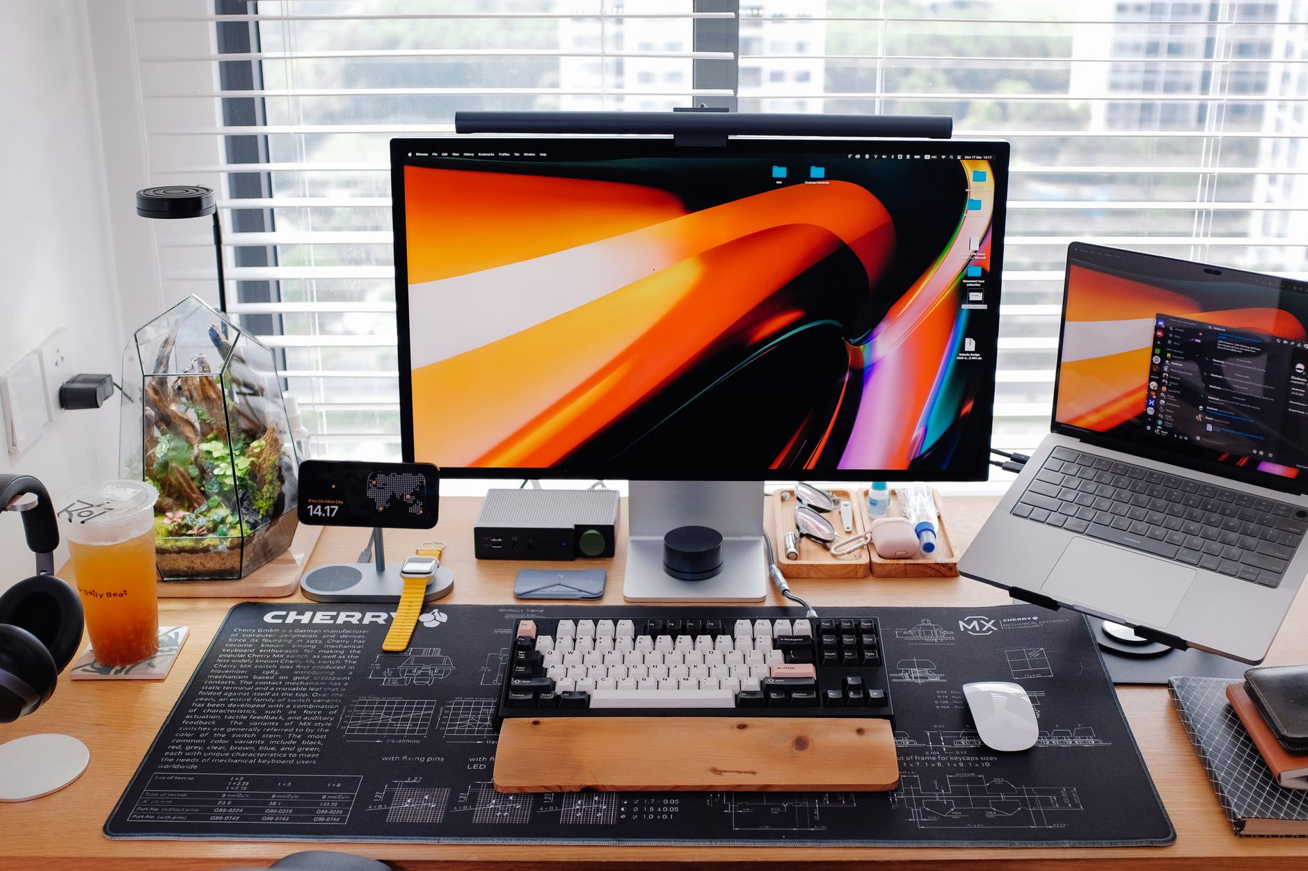 Stylish workspace with dual monitors, laptop, and gadgets on a wooden desk.