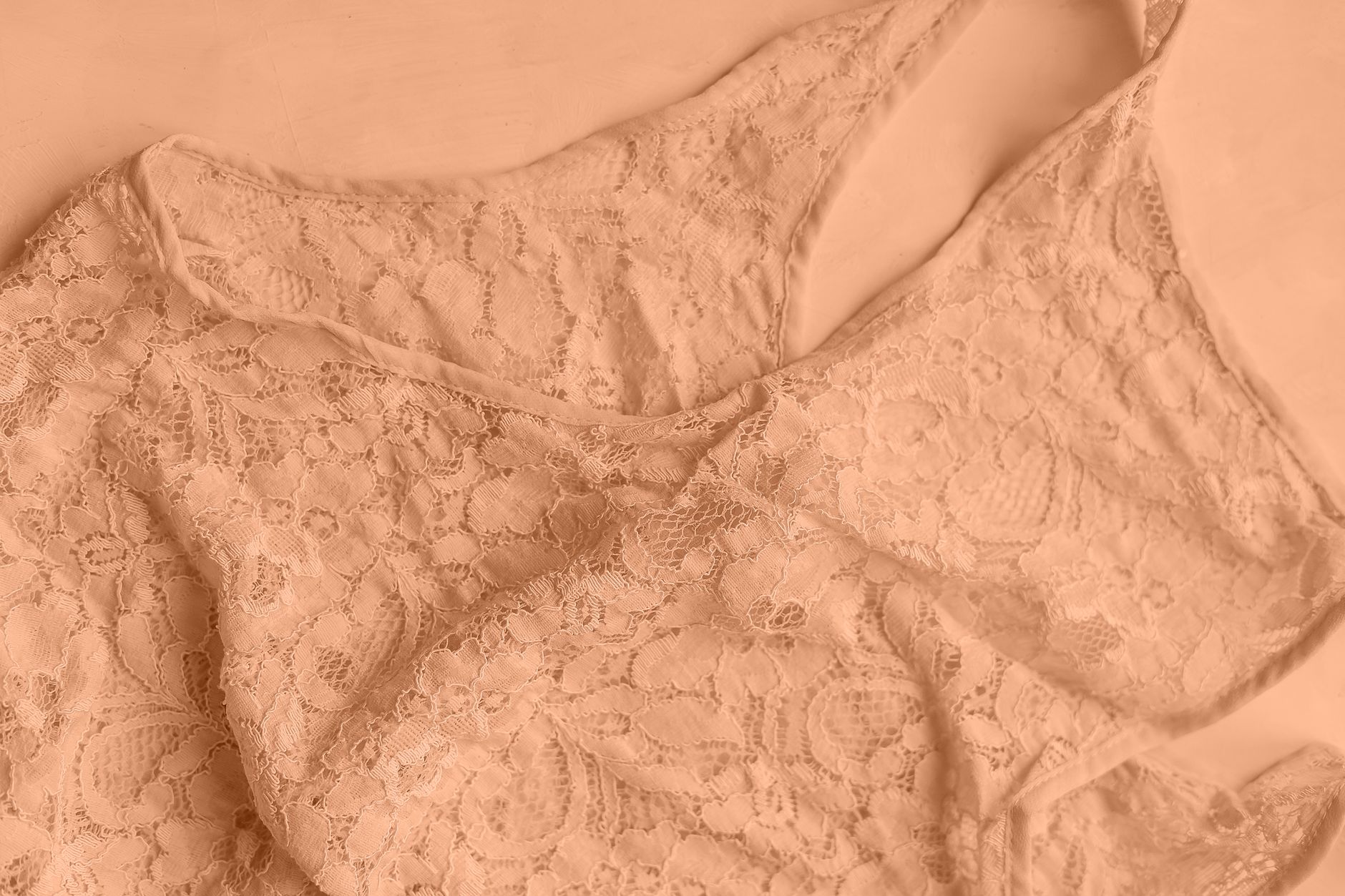Close-up photo of delicate lace lingerie in soft beige tones, perfect for fashion and elegance themes.