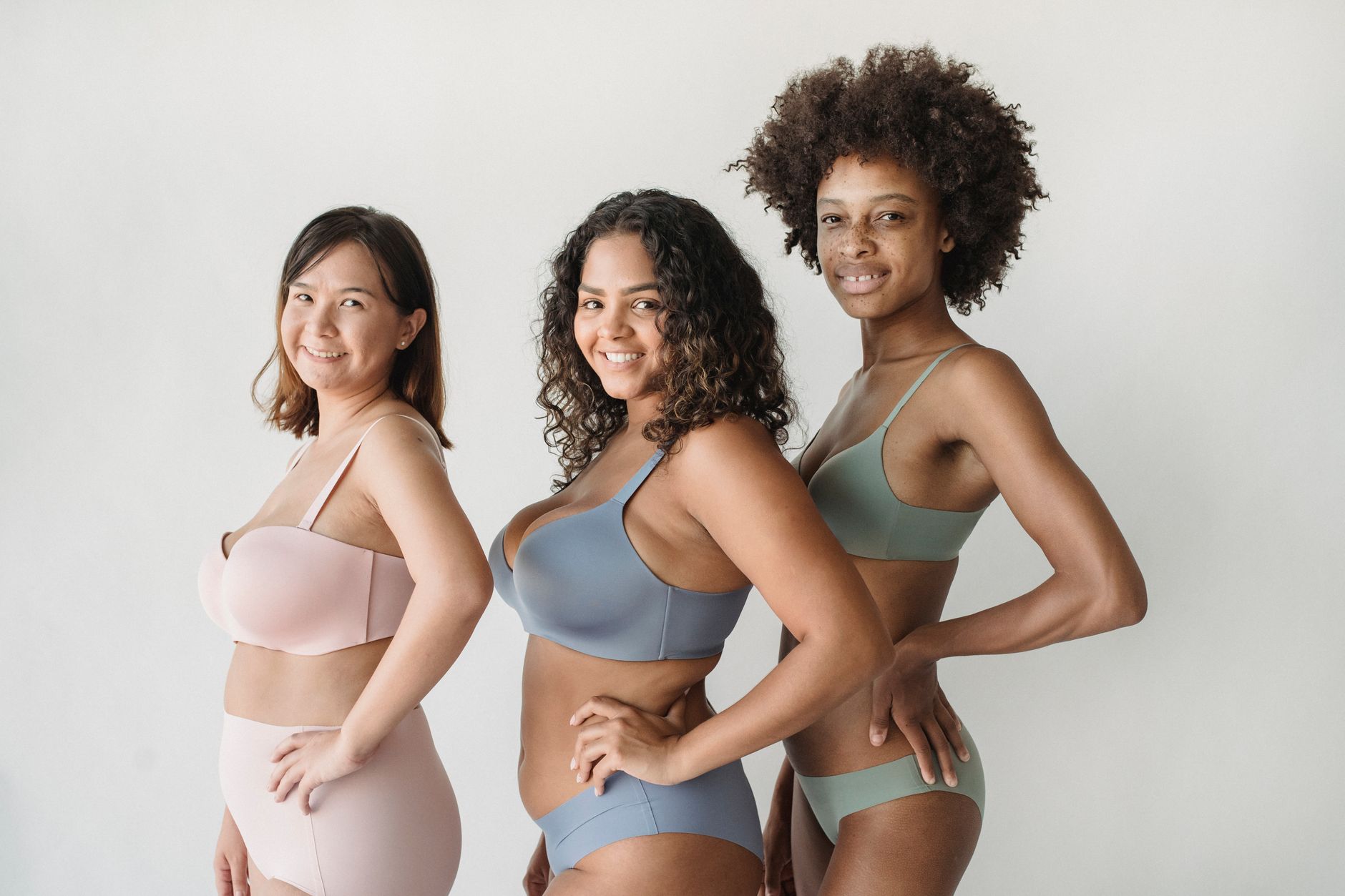 A group of diverse women confidently posing in stylish bras and underwear.