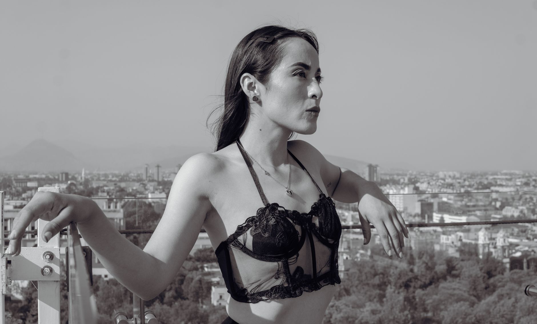 Black and white fashion portrait of a model posing on a rooftop in Mexico City.
