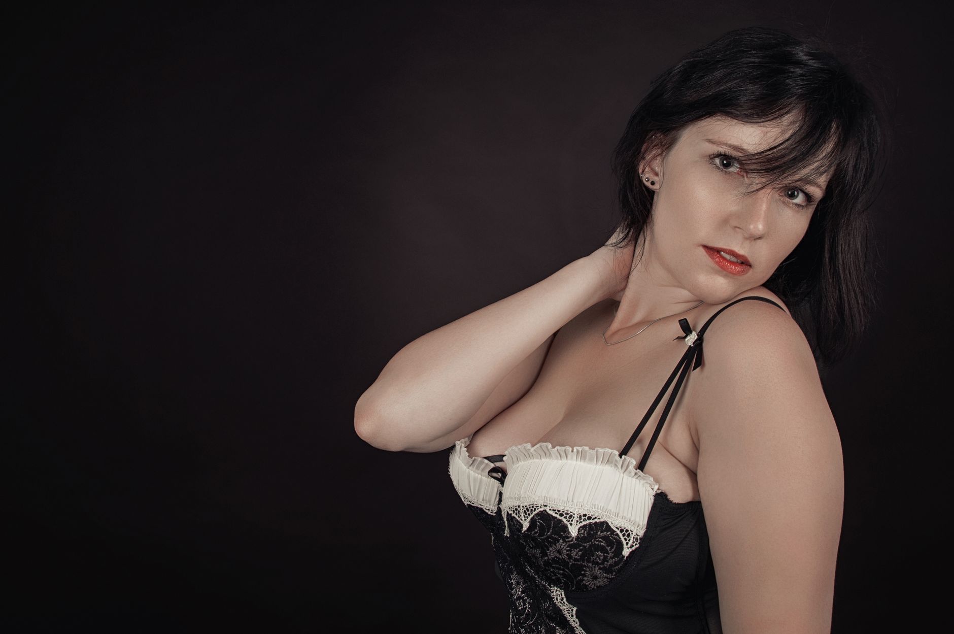 Sophisticated studio portrait of a woman showcasing elegance and style.