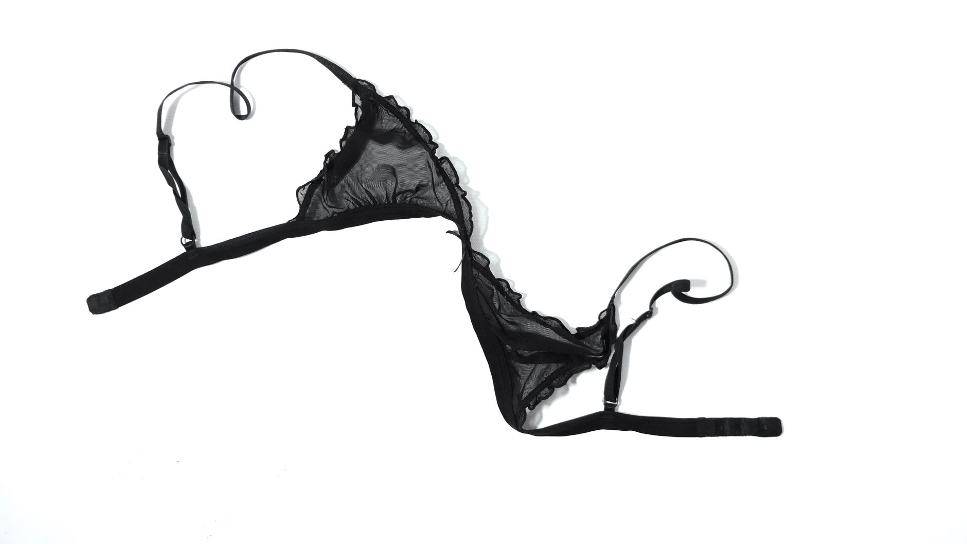 Single top bra piece of feminine lace black lingerie isolated on white background
