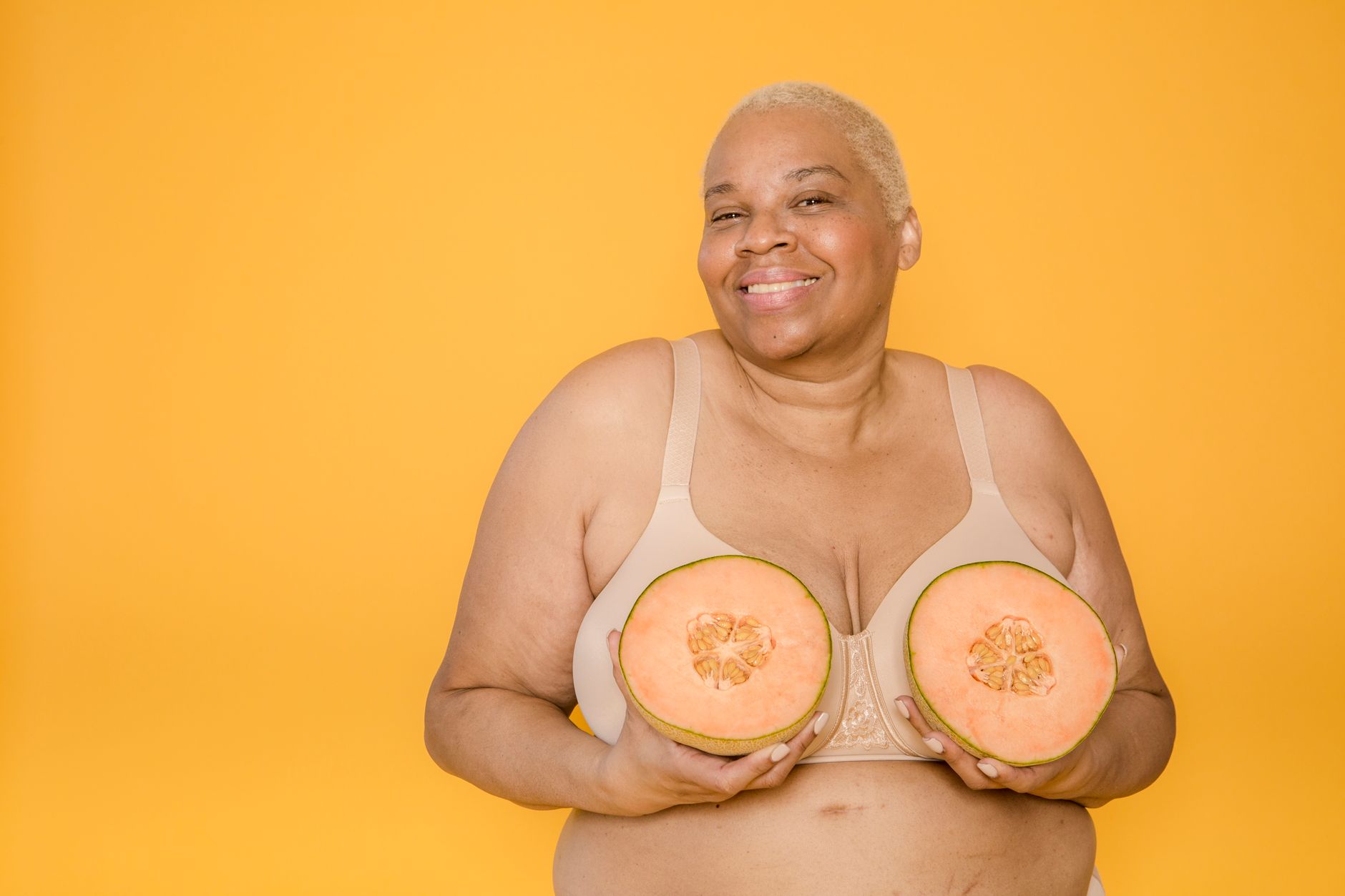Mulher plus size usando vestido tomara que caia com sutiã invisível, sorrindo