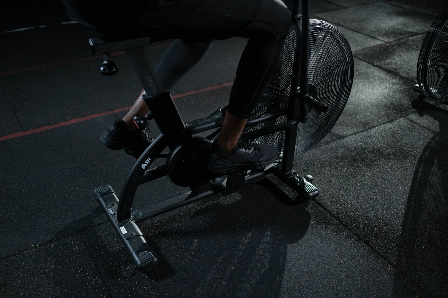 Focused indoor workout on exercise bike showcasing active lifestyle and fitness training.