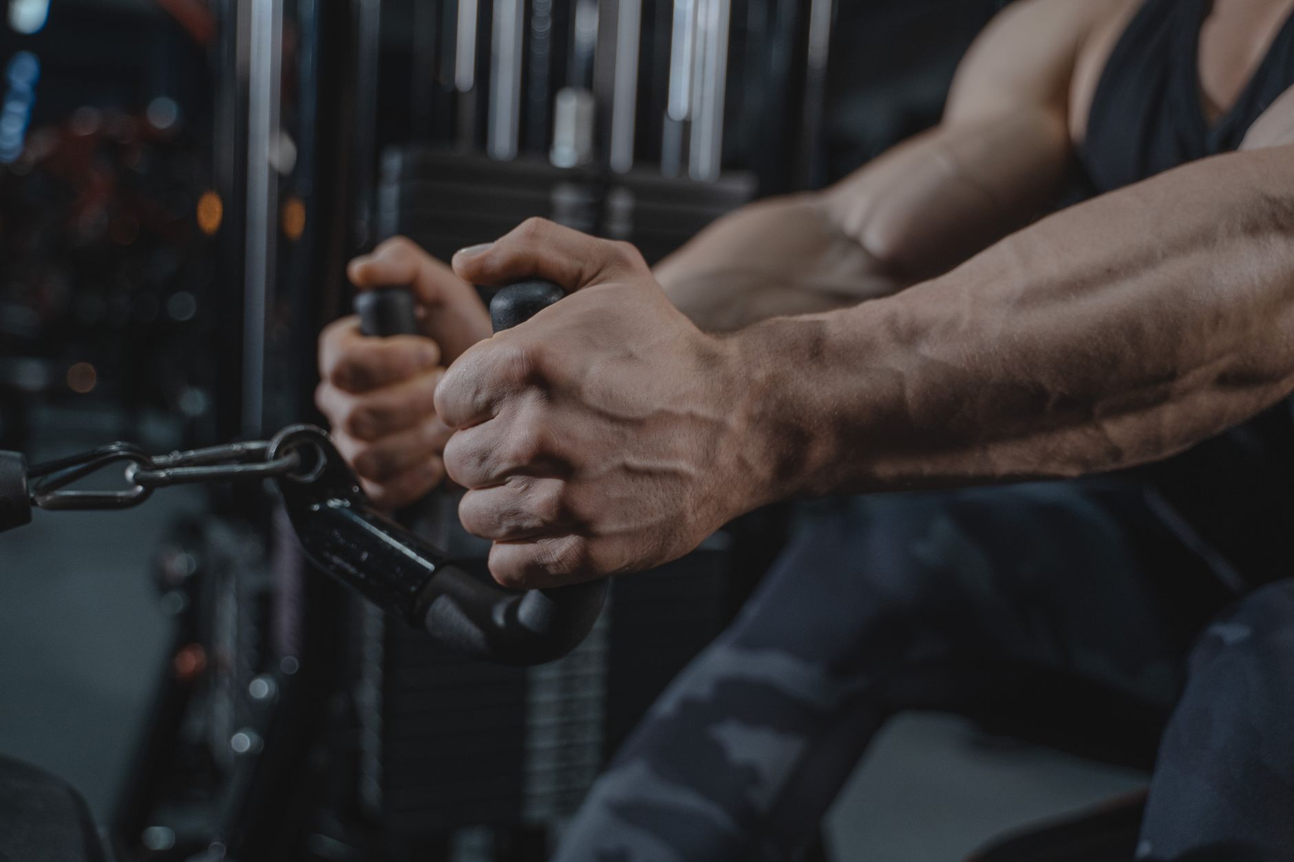 Male exercising with gym equipment, showcasing strength and determination in a fitness setting.
