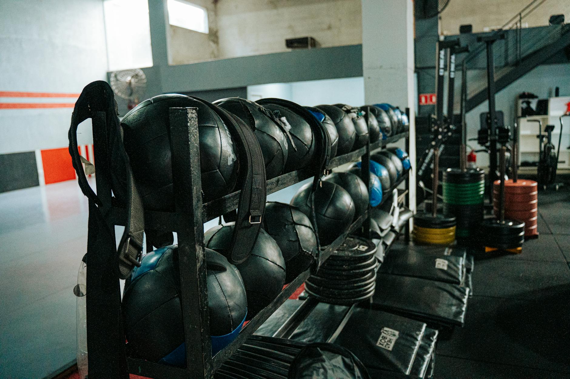 Well-equipped indoor gym featuring kettlebells, weights, and workout gear, perfect for fitness enthusiasts.