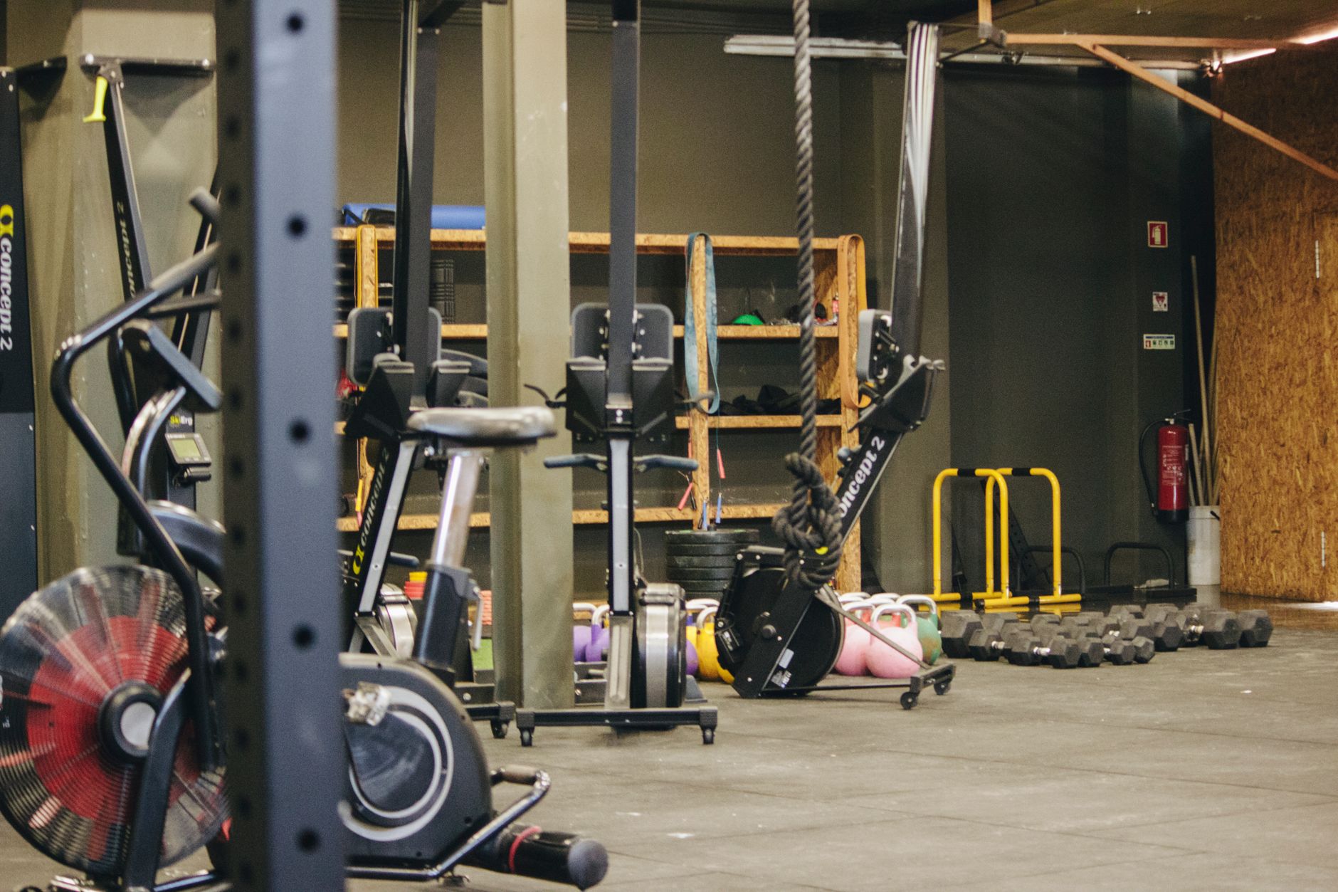 An indoor gym with various exercise equipment and weights ready for workout.
