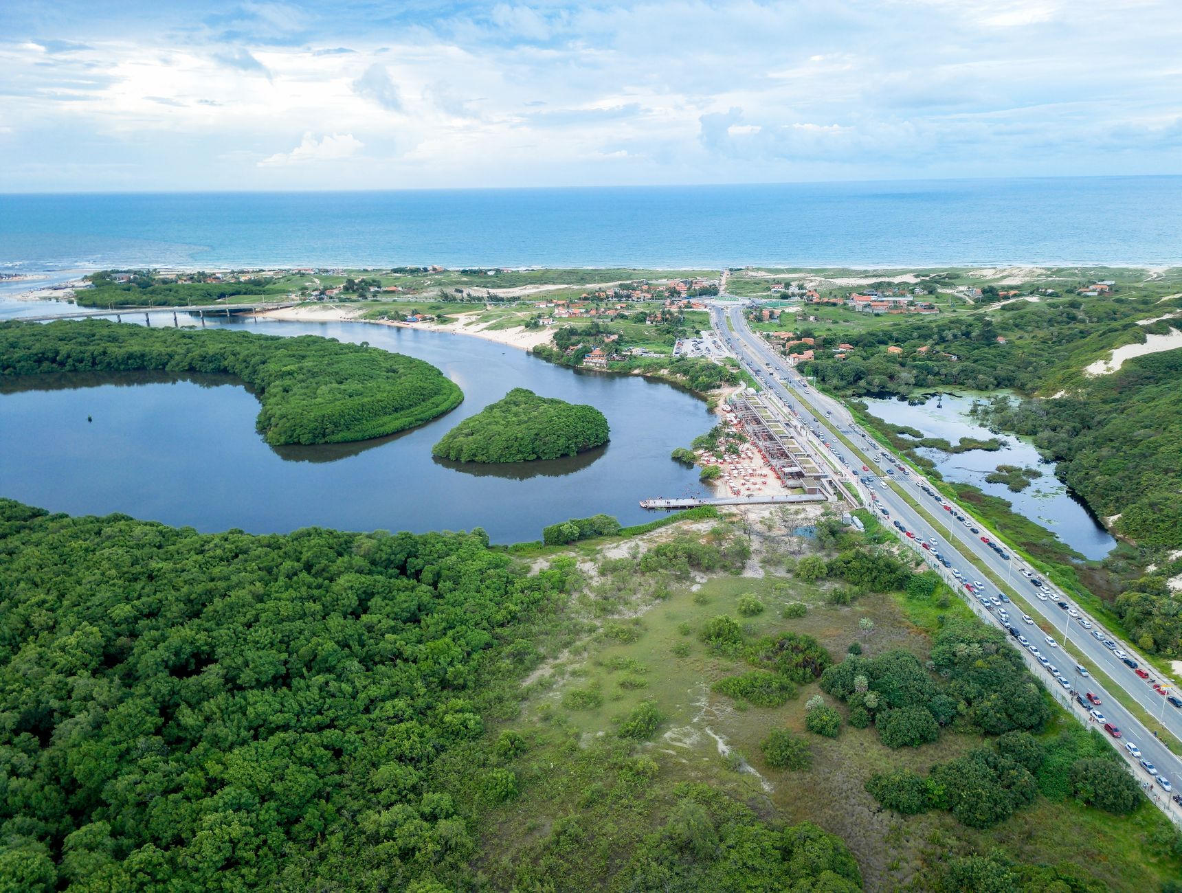 Breathtaking aerial view of coastal landscapes, lush greenery, and ocean near Fortaleza, Brazil.