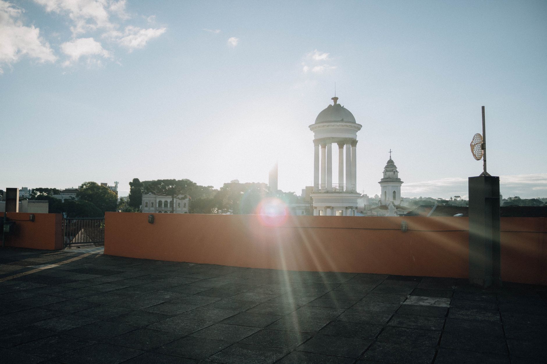 Sunrise view from a rooftop with towers and clear sky. Perfect for urban and architectural themes.