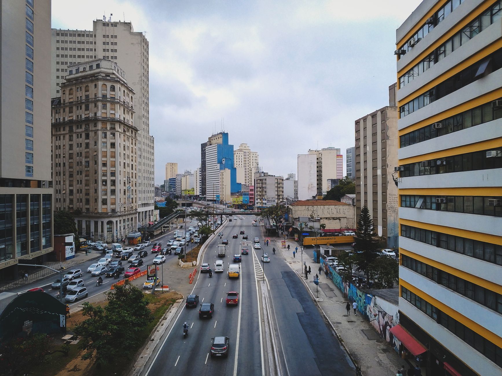 Cityscape of contemporary urban district with cars moving on road between modern multistory buildings in Sao Paulo city in Brazil