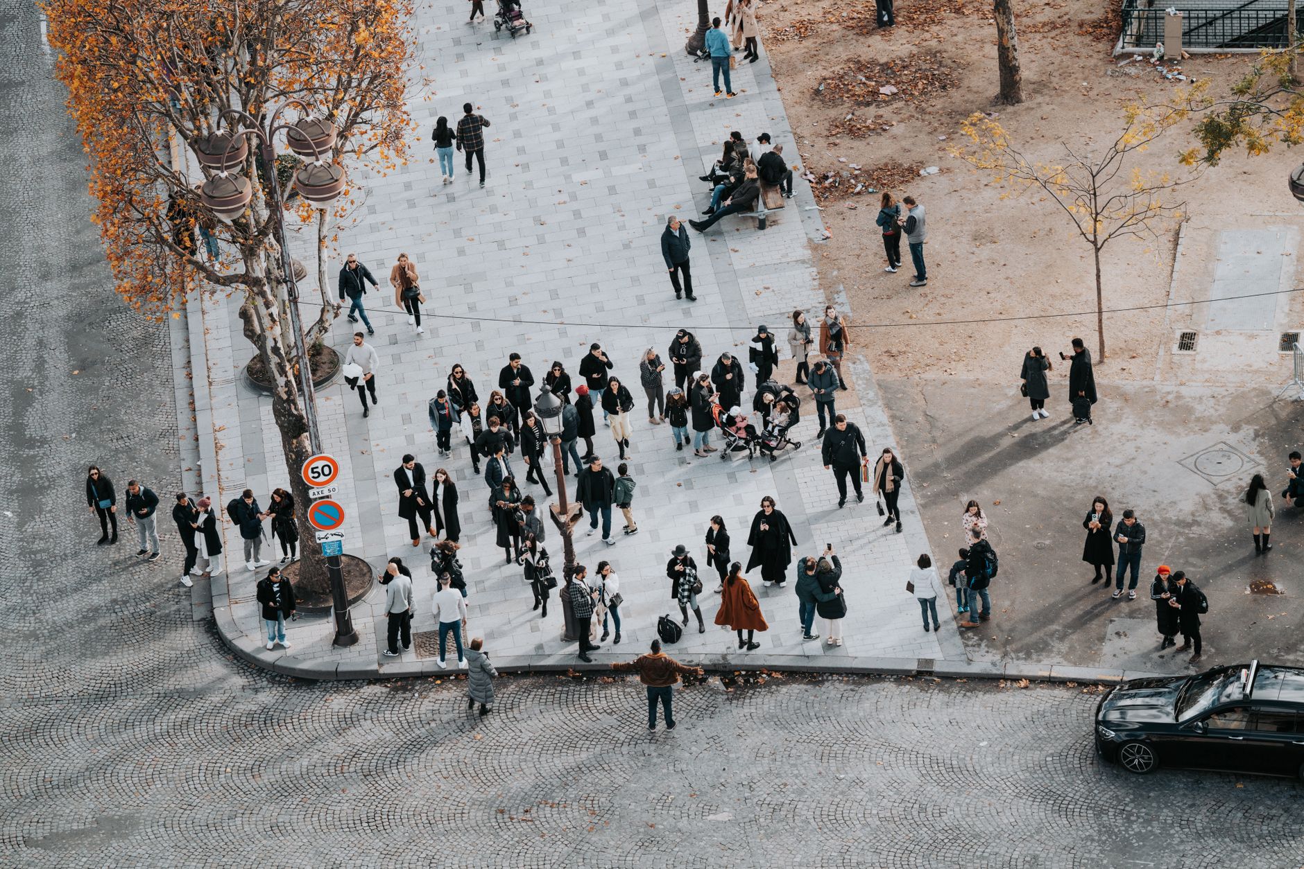 Crowd of people on a street in Paris during autumn from above view.