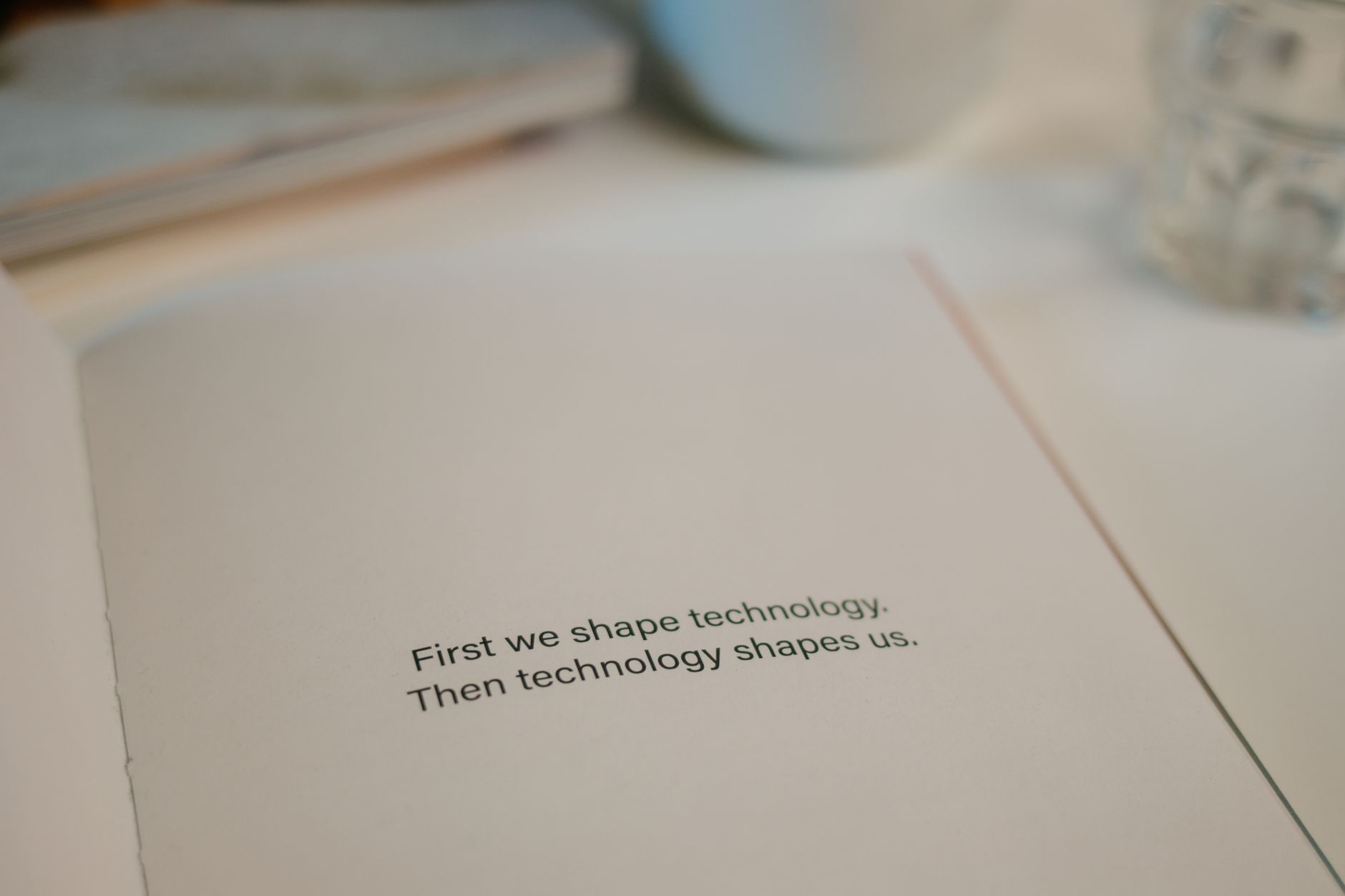Open book with quote on technology's influence, perfect for tech inspiration.
