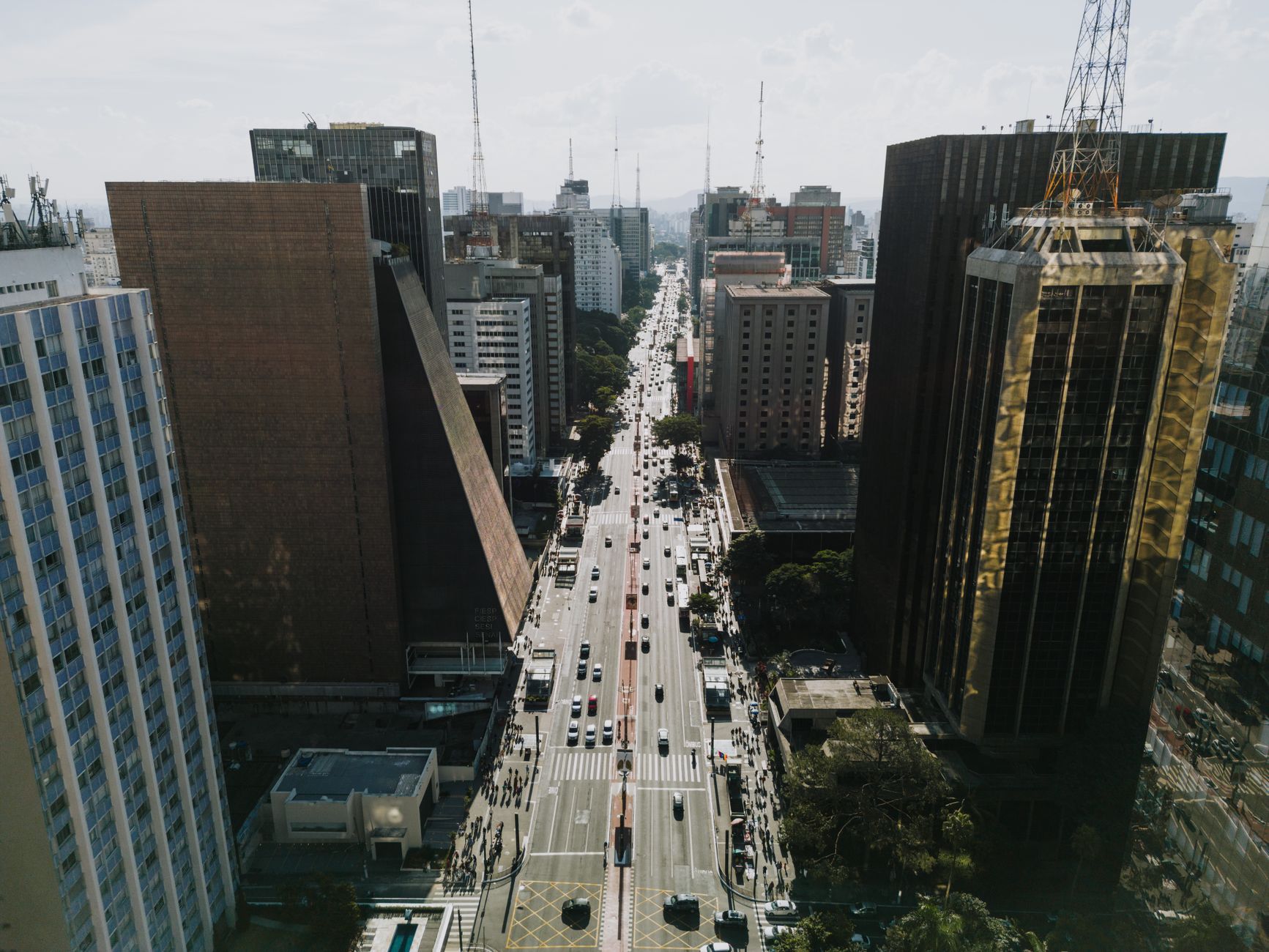 A vibrant aerial view of Paulista Avenue showcasing skyscrapers and urban life in São Paulo, Brazil.