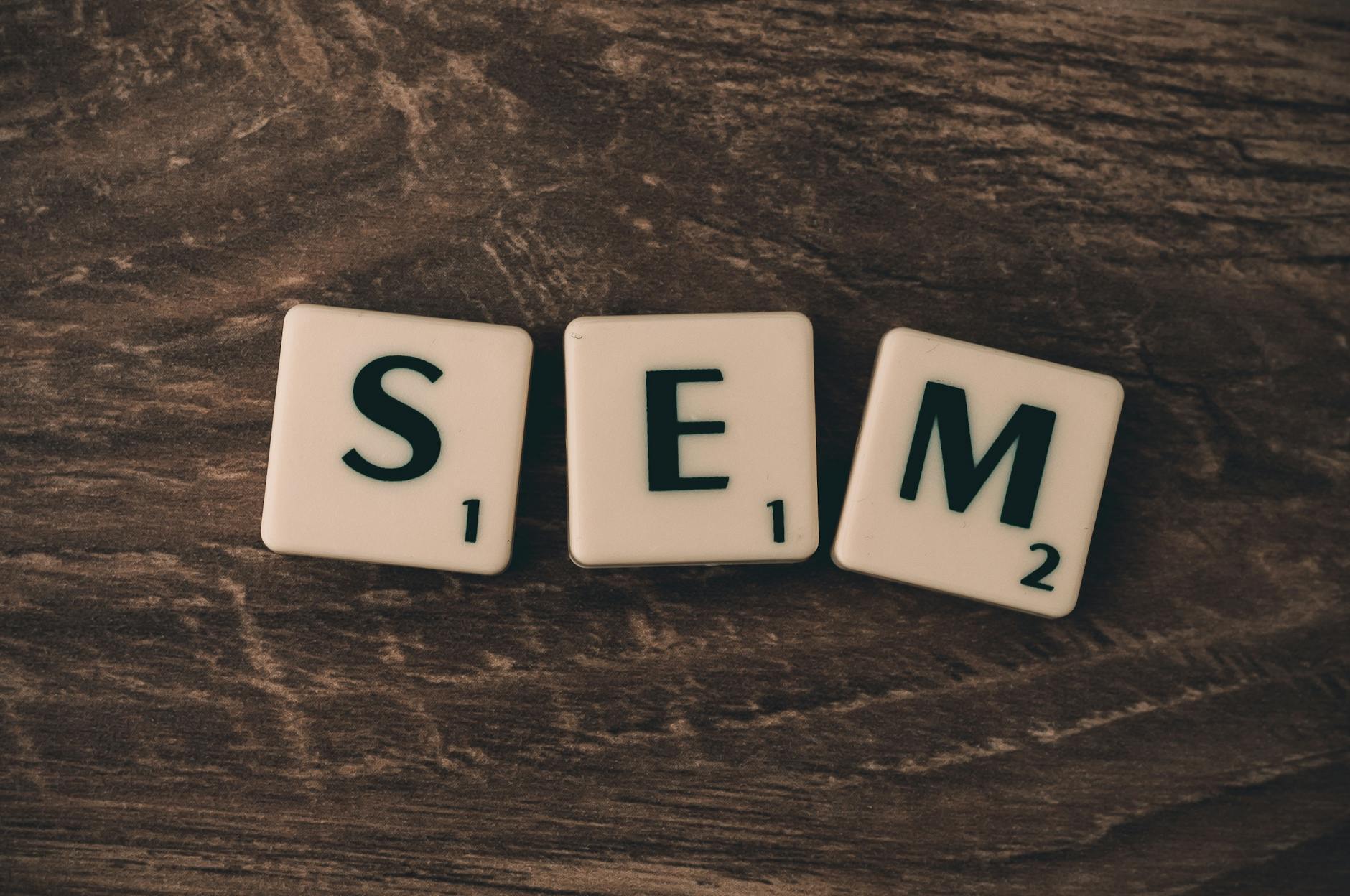 Scrabble tiles spelling SEO Audit on wooden surface, symbolizing digital marketing strategies.